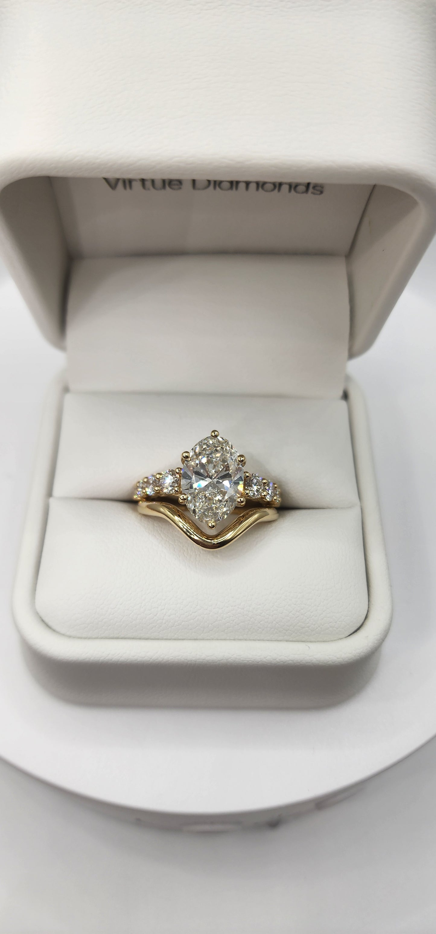 "The Cathy" 3 Carat Oval Lab Grown Diamond, G, VS1 set in 14k Yellow Gold Band with Round Accent Diamonds and Matching Curved Band