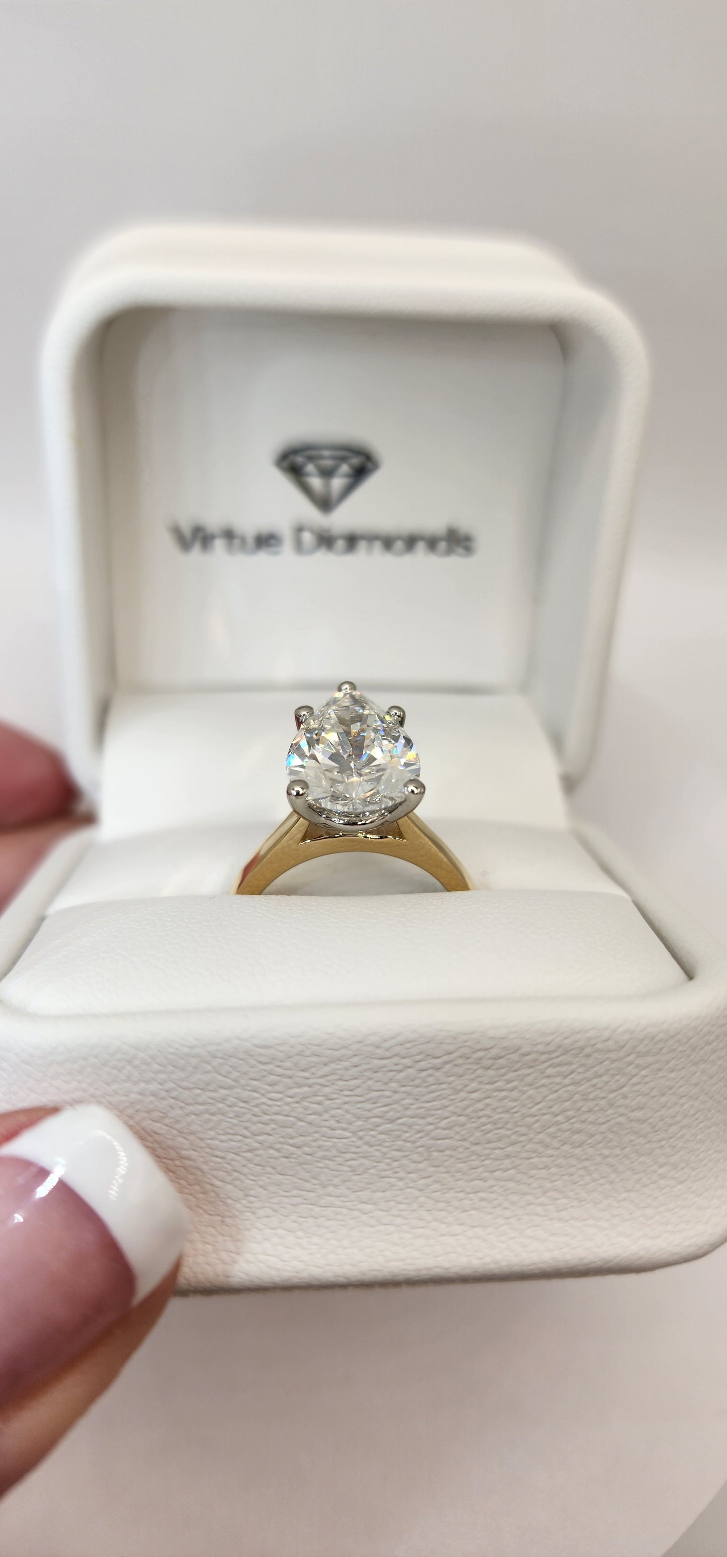 "The Dottie" is a 5.49 Carat Pear Lab Grown Diamond F/VS1 on a 14k Yellow Gold Cathedral Solitaire with 14k White Gold Prongs/Head