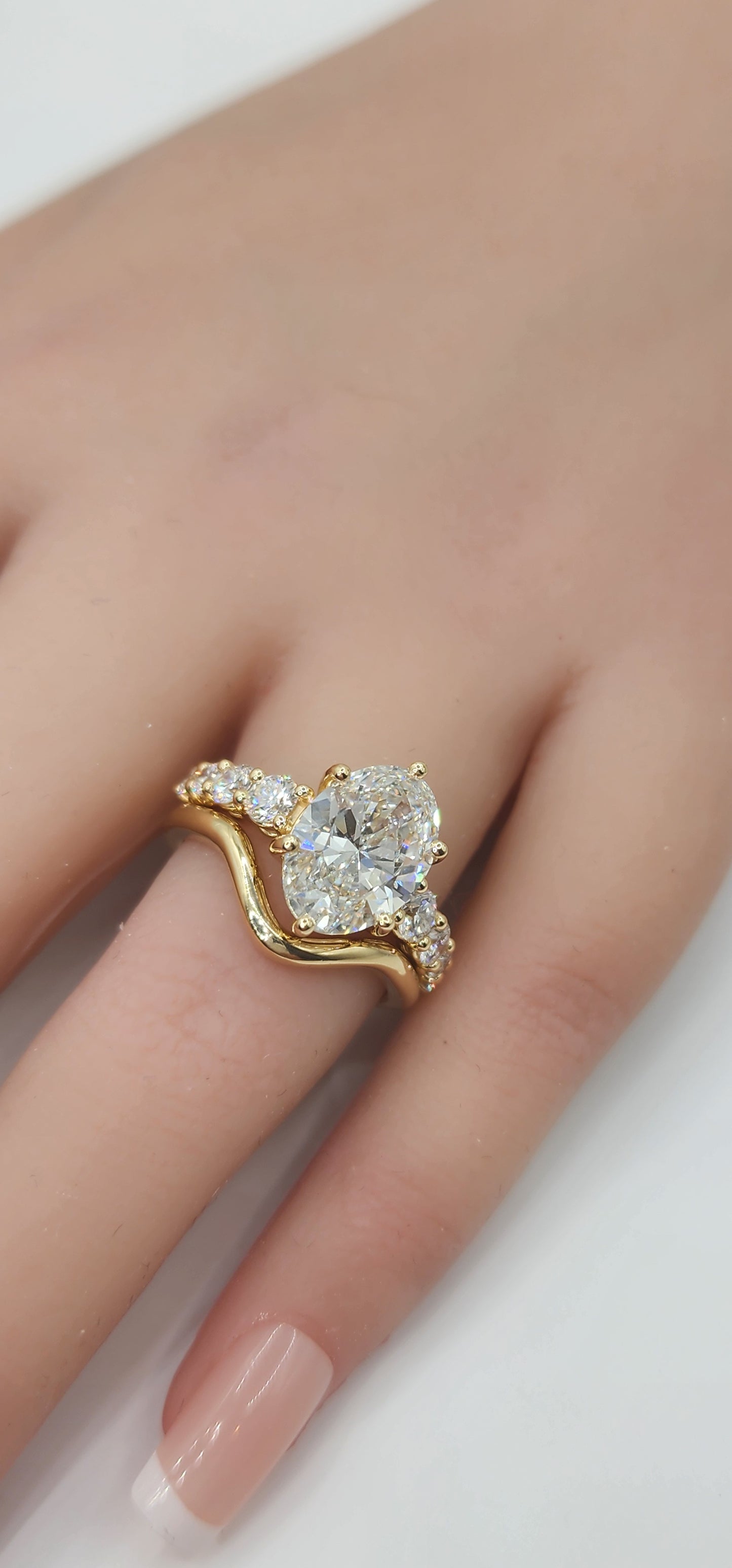 "The Cathy" 3 Carat Oval Lab Grown Diamond, G, VS1 set in 14k Yellow Gold Band with Round Accent Diamonds and Matching Curved Band