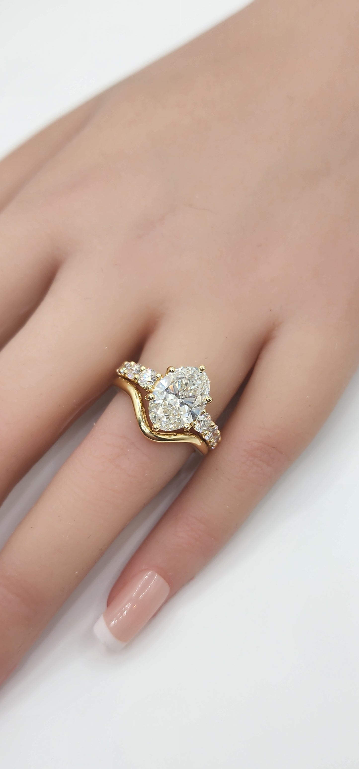 "The Cathy" 3 Carat Oval Lab Grown Diamond, G, VS1 set in 14k Yellow Gold Band with Round Accent Diamonds and Matching Curved Band