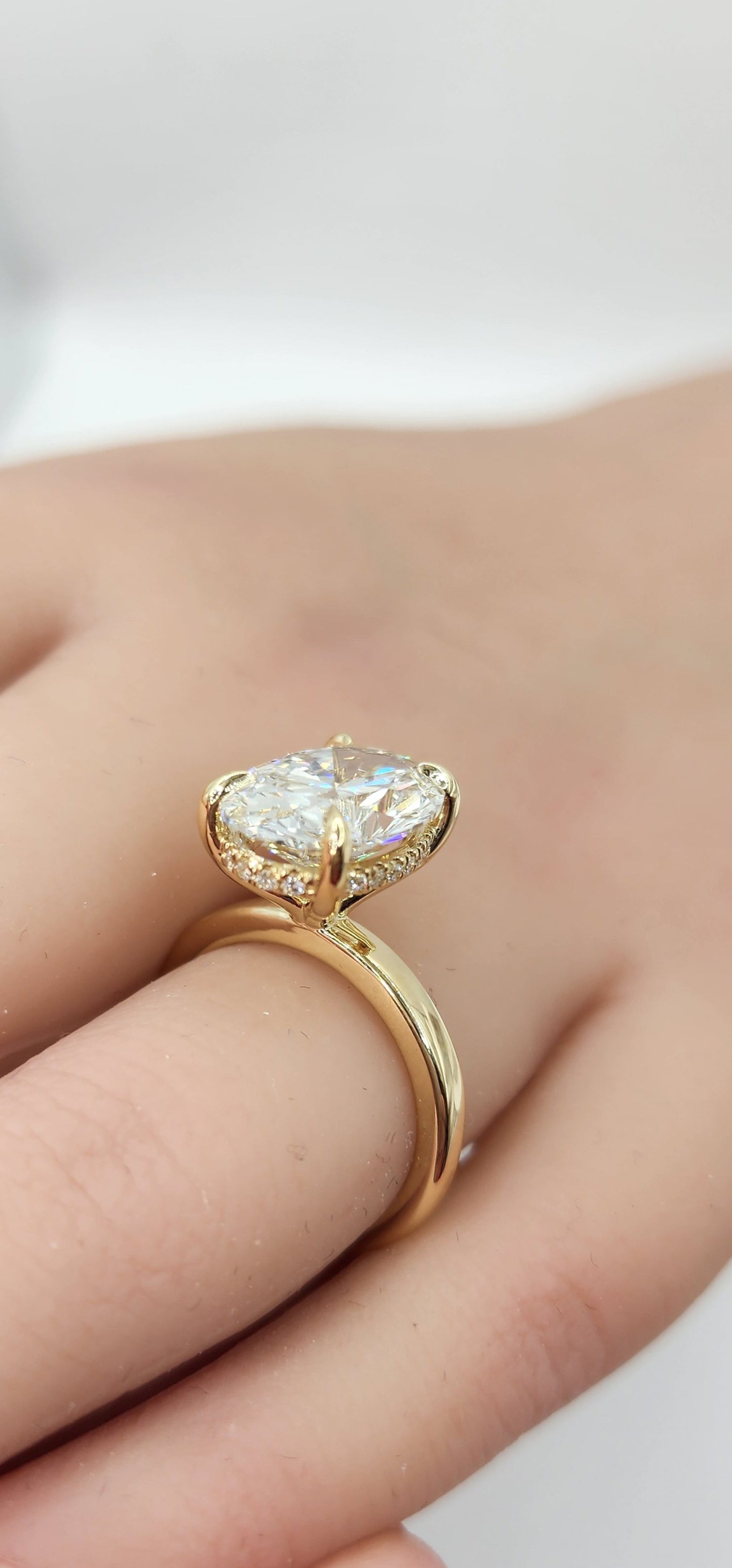 "The Kelli" 5.48 Carat Oval Lab Grown Diamond, G VS1 on a 14k Yellow Gold 1.8mm band with Hidden Halo and Yellow Gold Claw Prongs