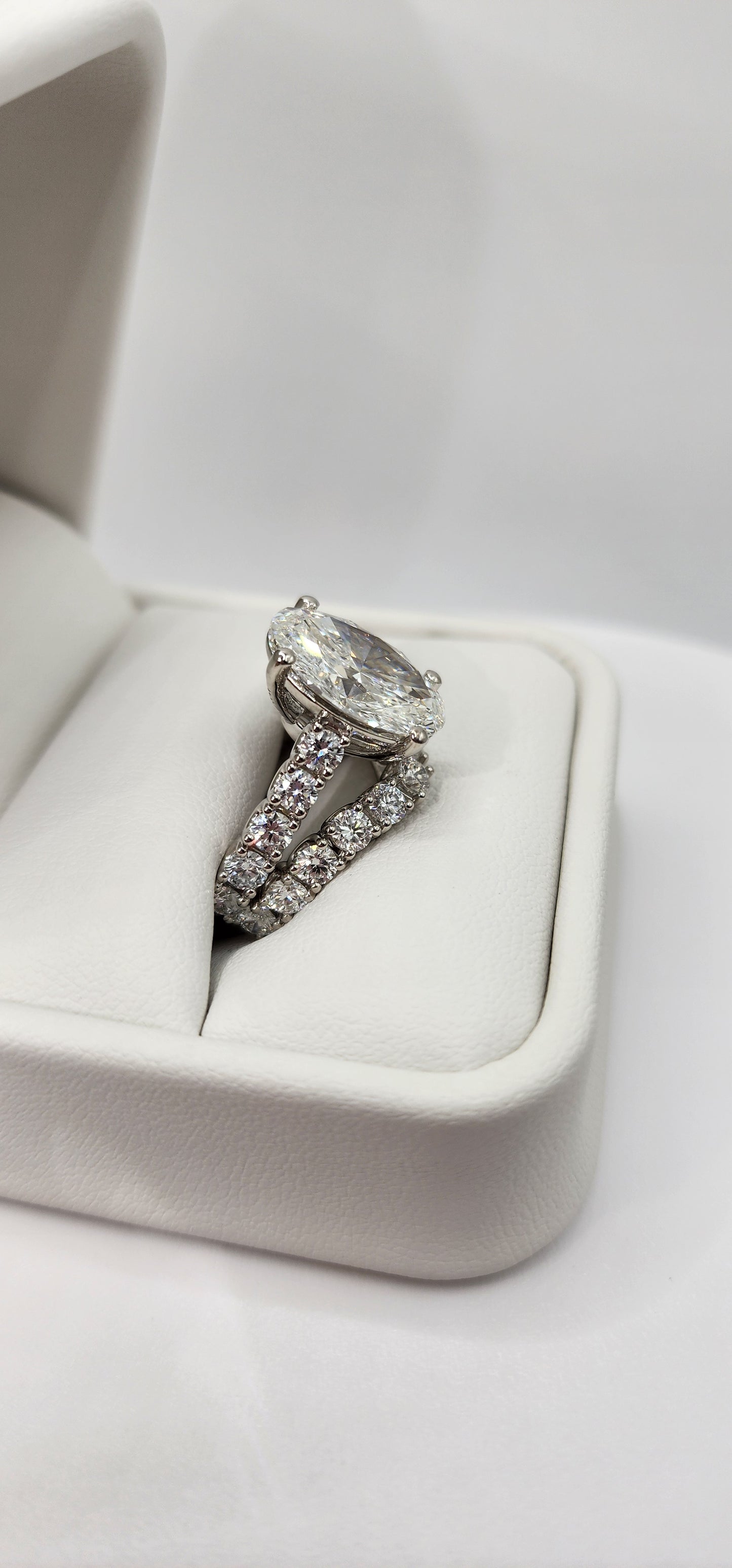 "The Marisol" is a 5 Carat Oval Lab Gown Diamond, F/VS1 set in 14k White Gold with Accent diamonds and a contoured wedding band