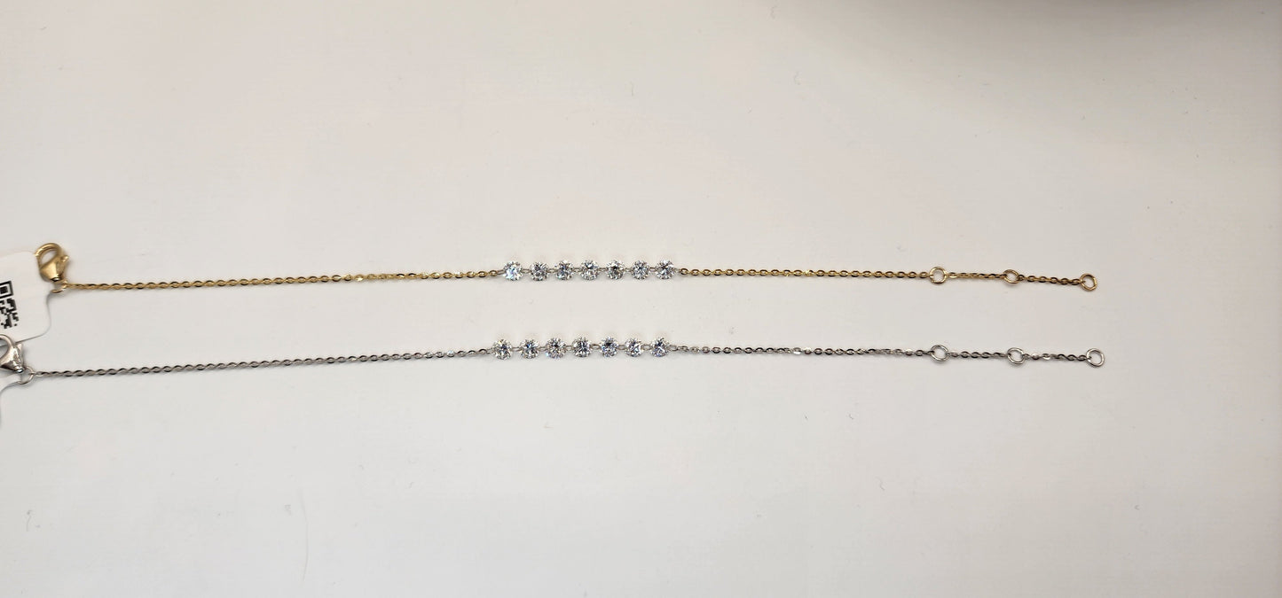Two gold and white gold diamond bracelets on a light gray background