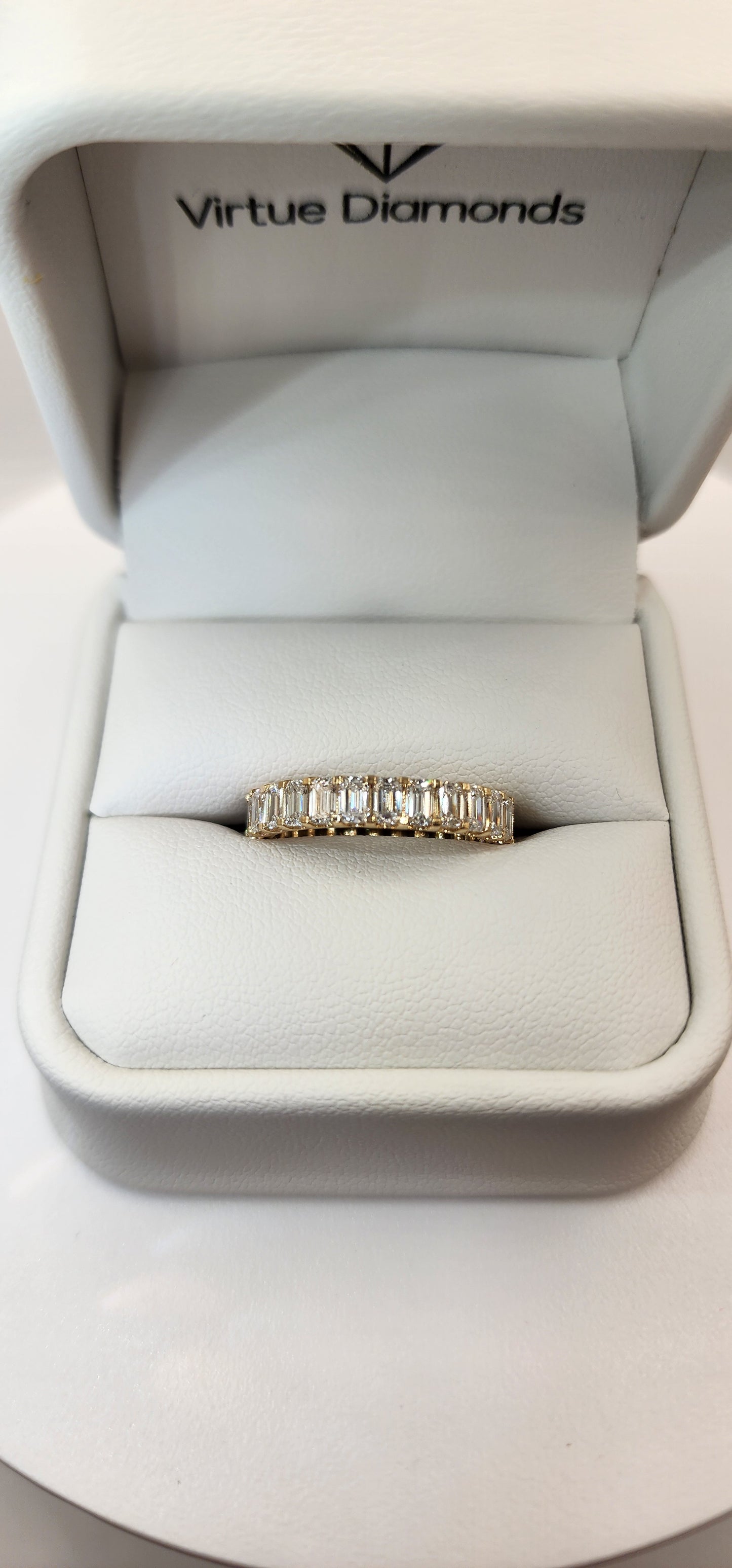 Yellow Gold and Diamond ring in a 'Virtue Diamonds' box on a white background