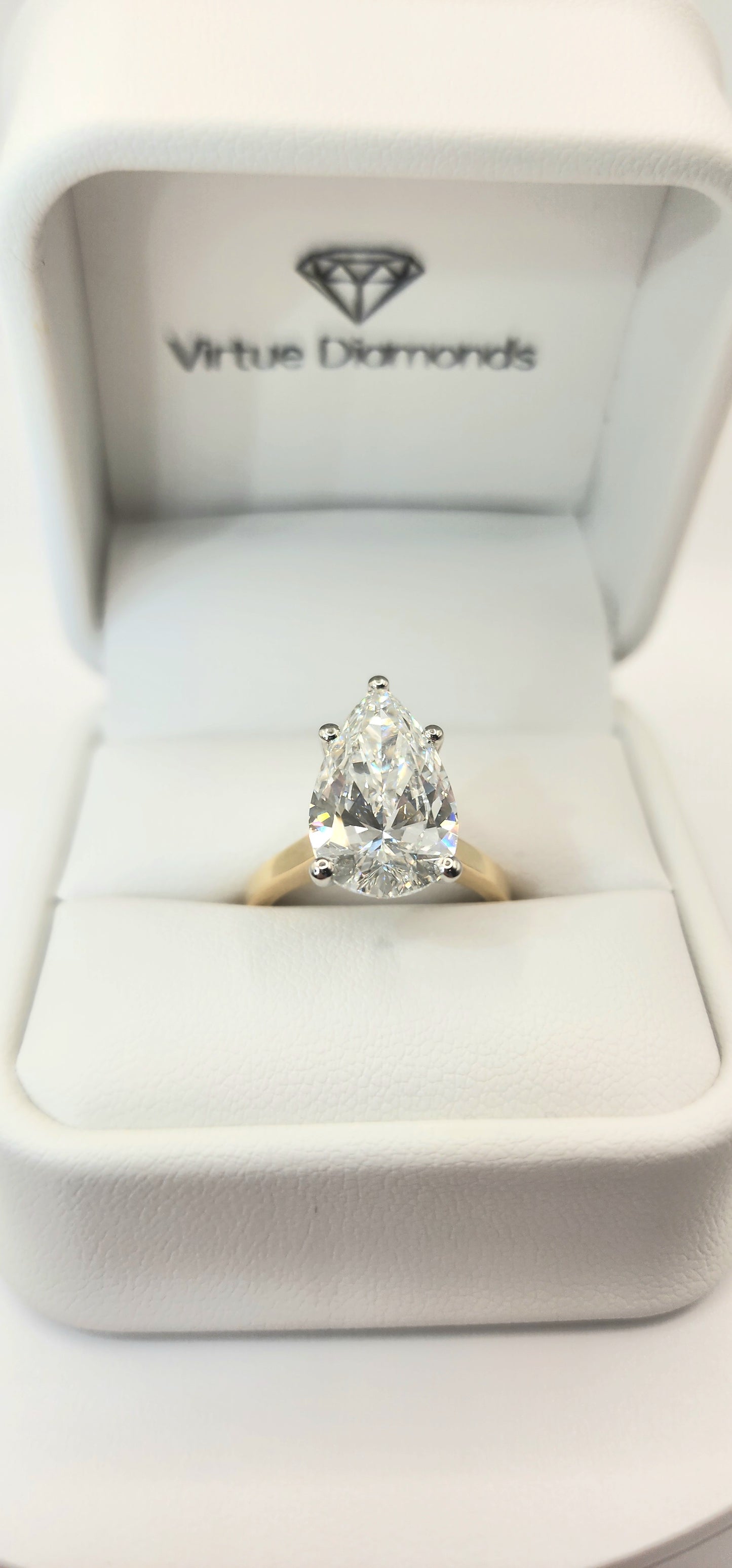 "The Dottie" is a 5.49 Carat Pear Lab Grown Diamond F/VS1 on a 14k Yellow Gold Cathedral Solitaire with 14k White Gold Prongs/Head