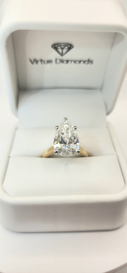 "The Dottie" is a 5.49 Carat Pear Lab Grown Diamond F/VS1 on a 14k Yellow Gold Cathedral Solitaire with 14k White Gold Prongs/Head