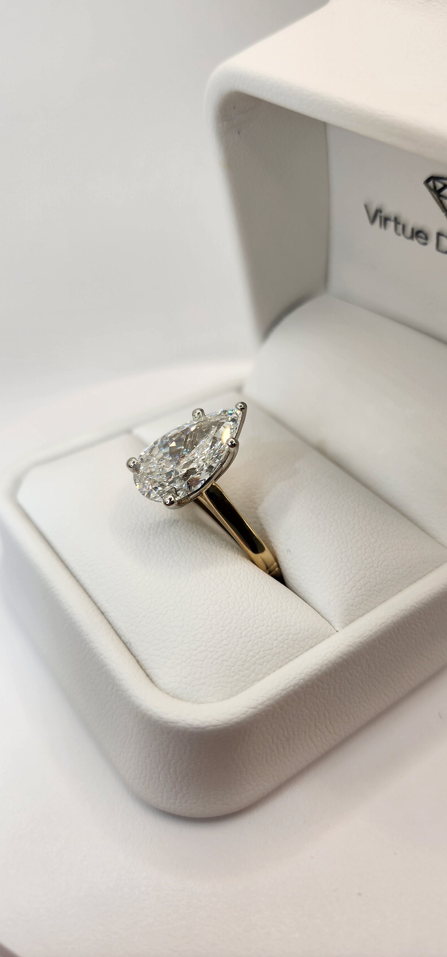 "The Dottie" is a 5.49 Carat Pear Lab Grown Diamond F/VS1 on a 14k Yellow Gold Cathedral Solitaire with 14k White Gold Prongs/Head