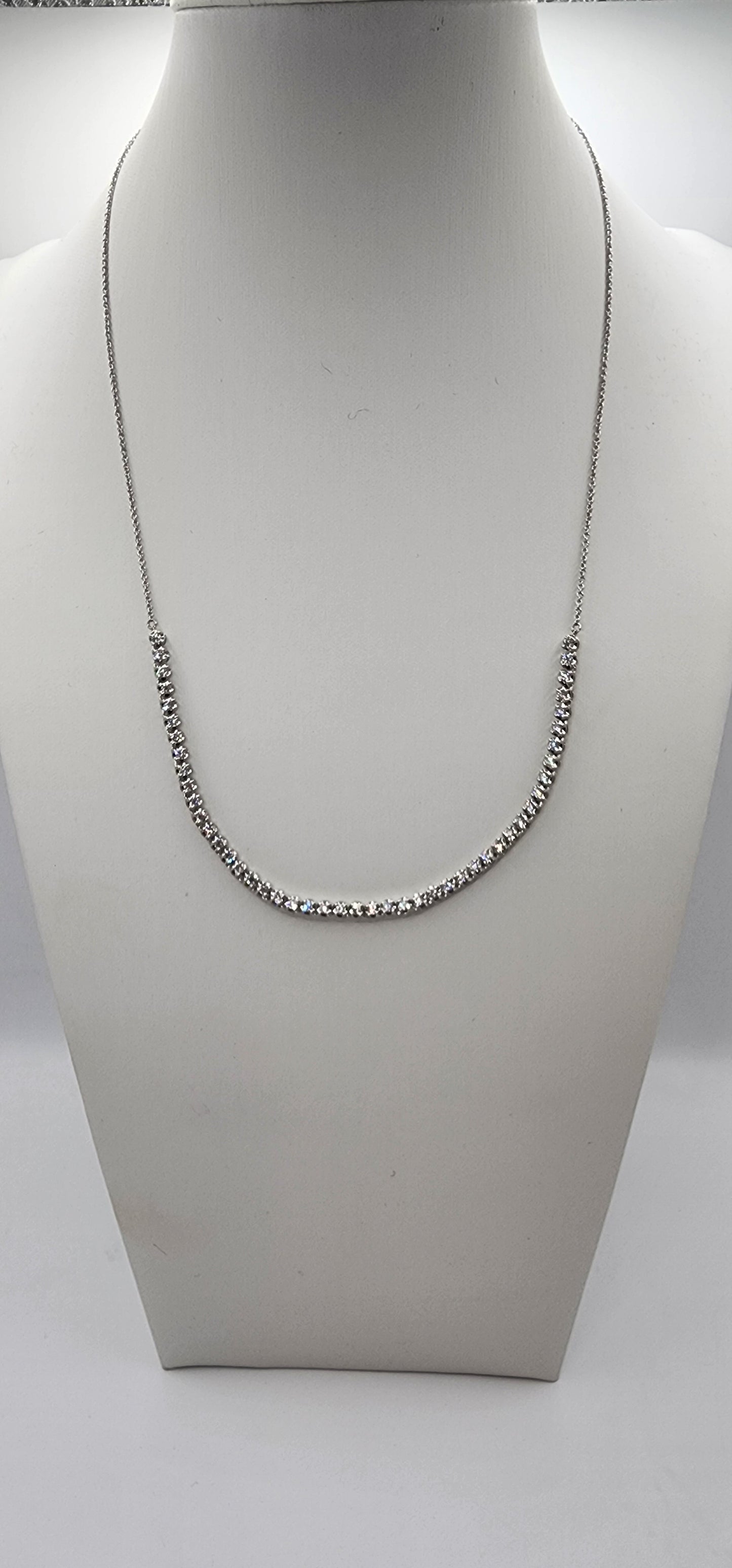 White Gold and Diamond necklace on a mannequin bust against a white background