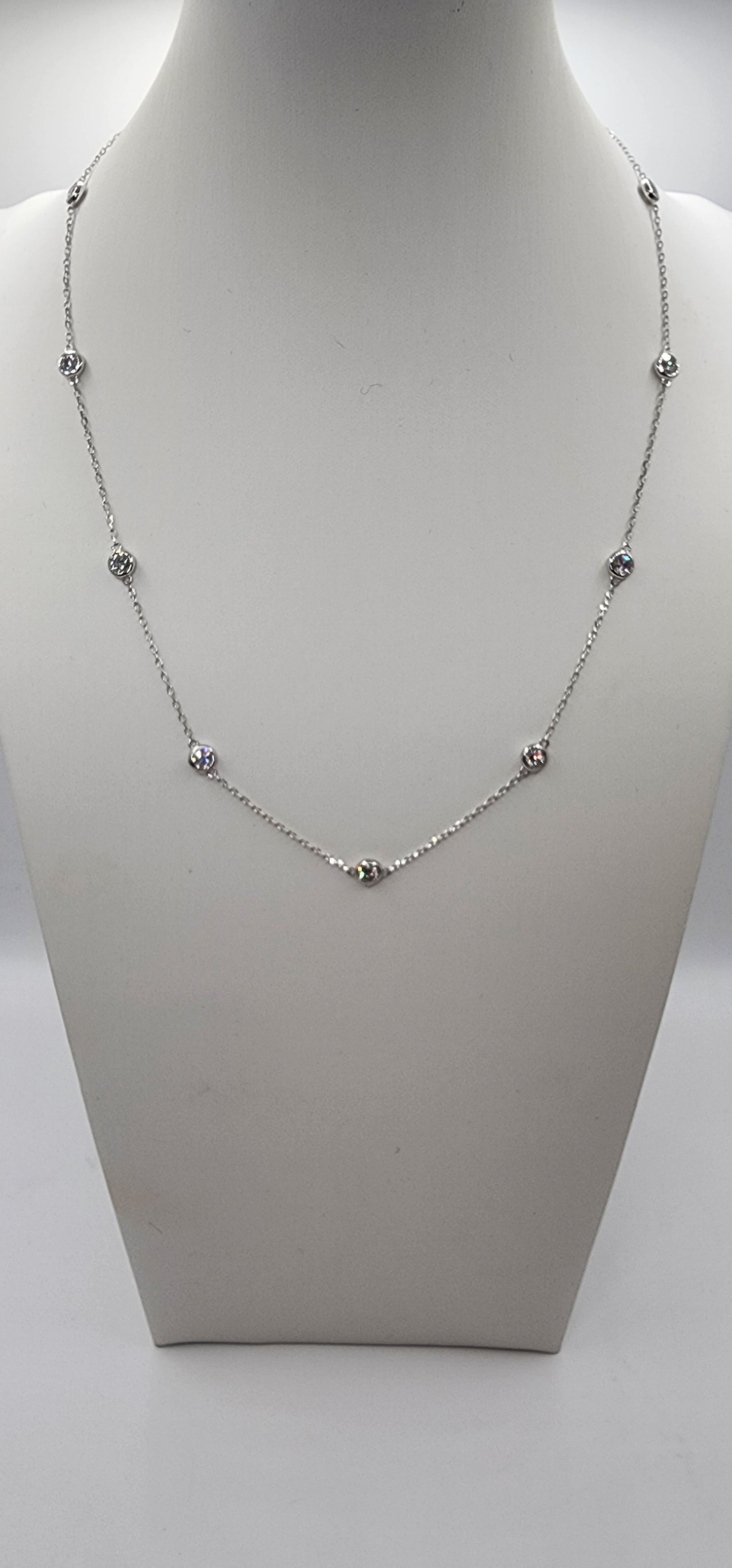 White Gold and Diamond Station Necklace on a mannequin bust against a white background