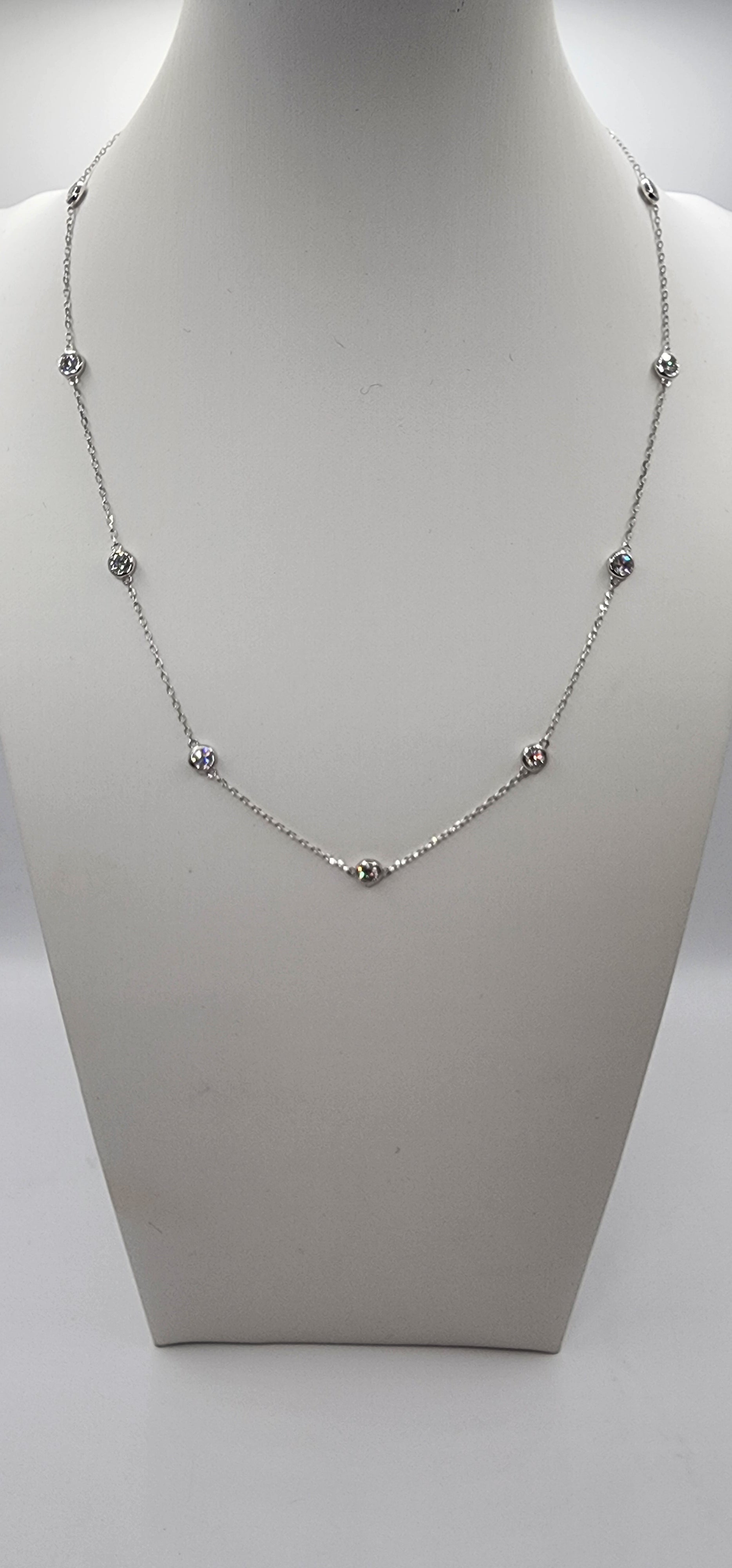 White Gold and Diamond Station Necklace on a mannequin bust against a white background