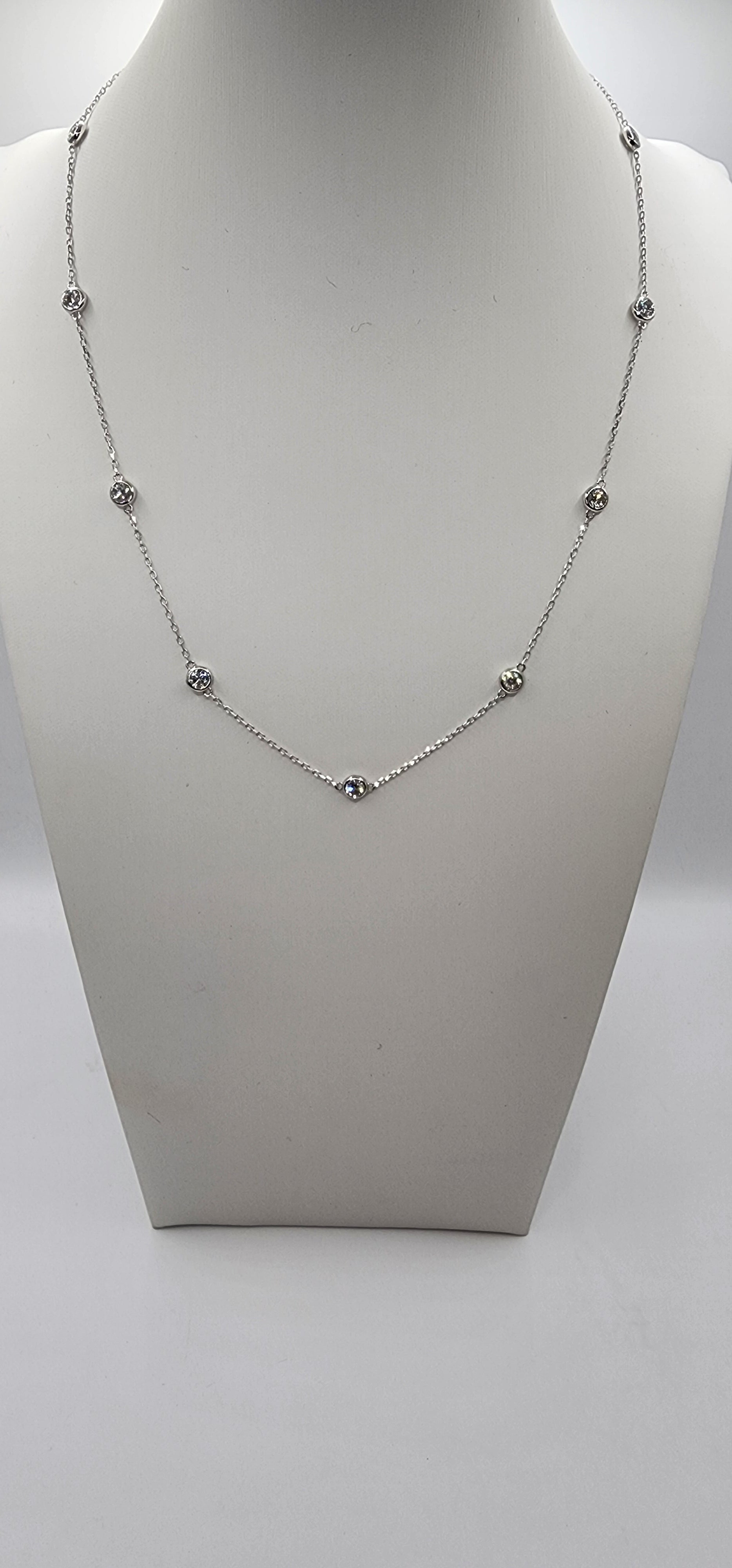 White Gold and Diamond Station Necklace on a mannequin bust against a white background