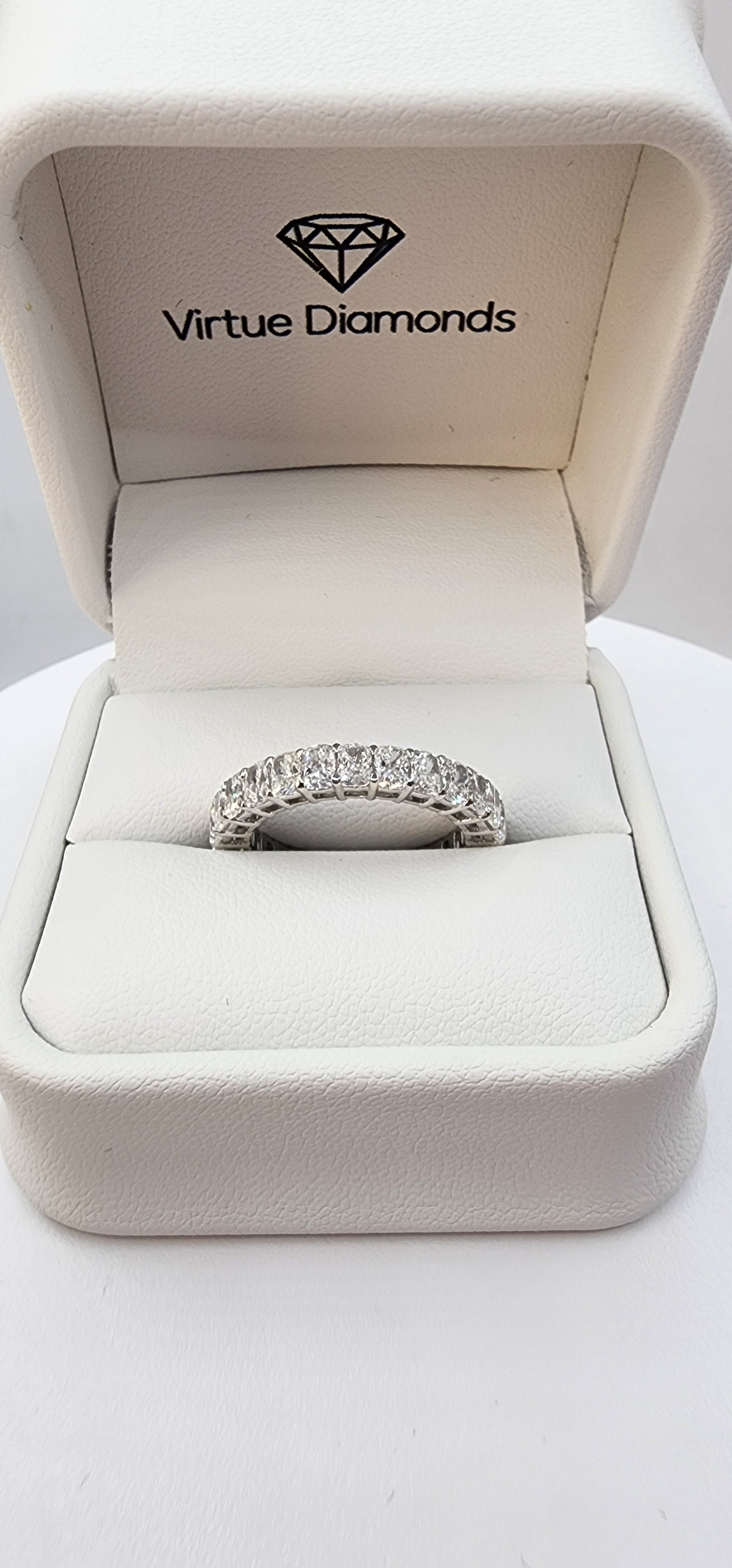 Diamond ring in a Virtue Diamonds box on a white background