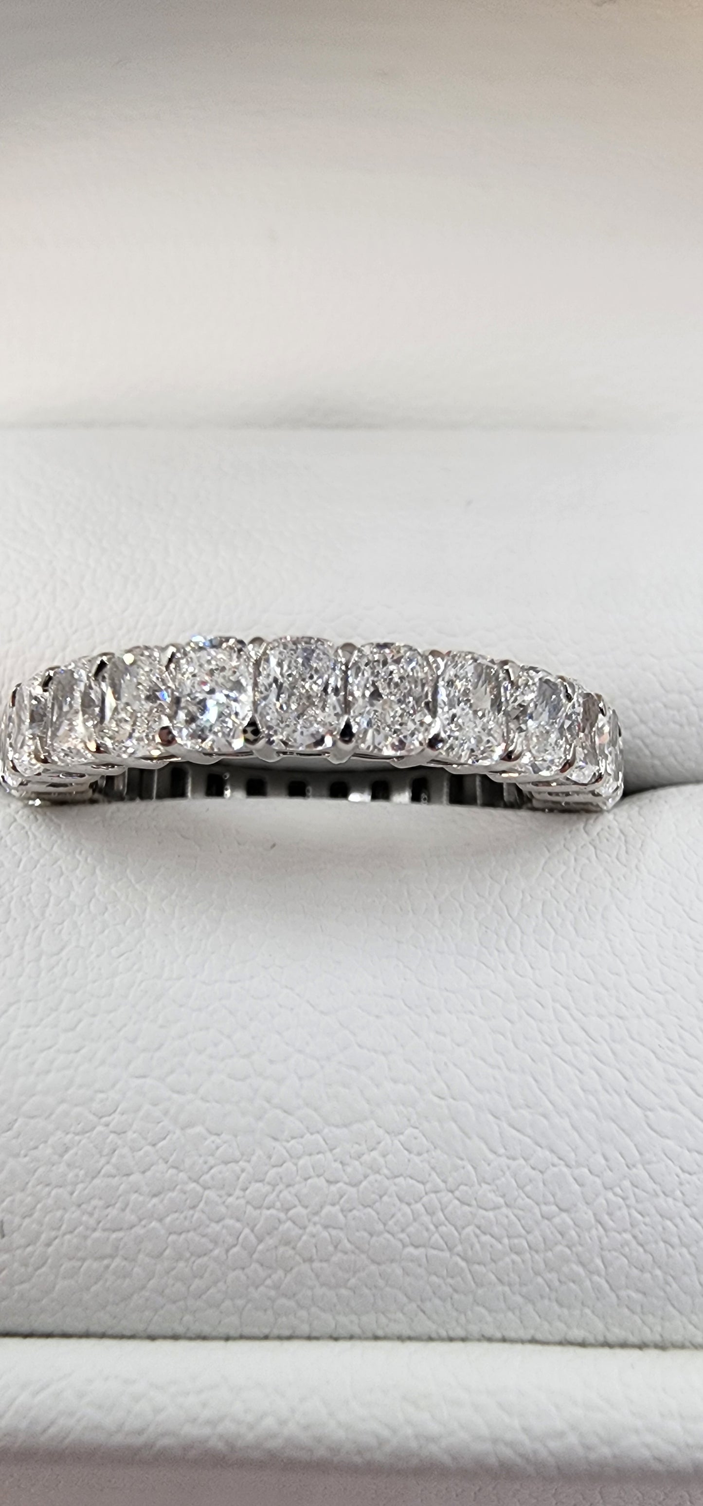 Diamond ring on a white cushioned surface