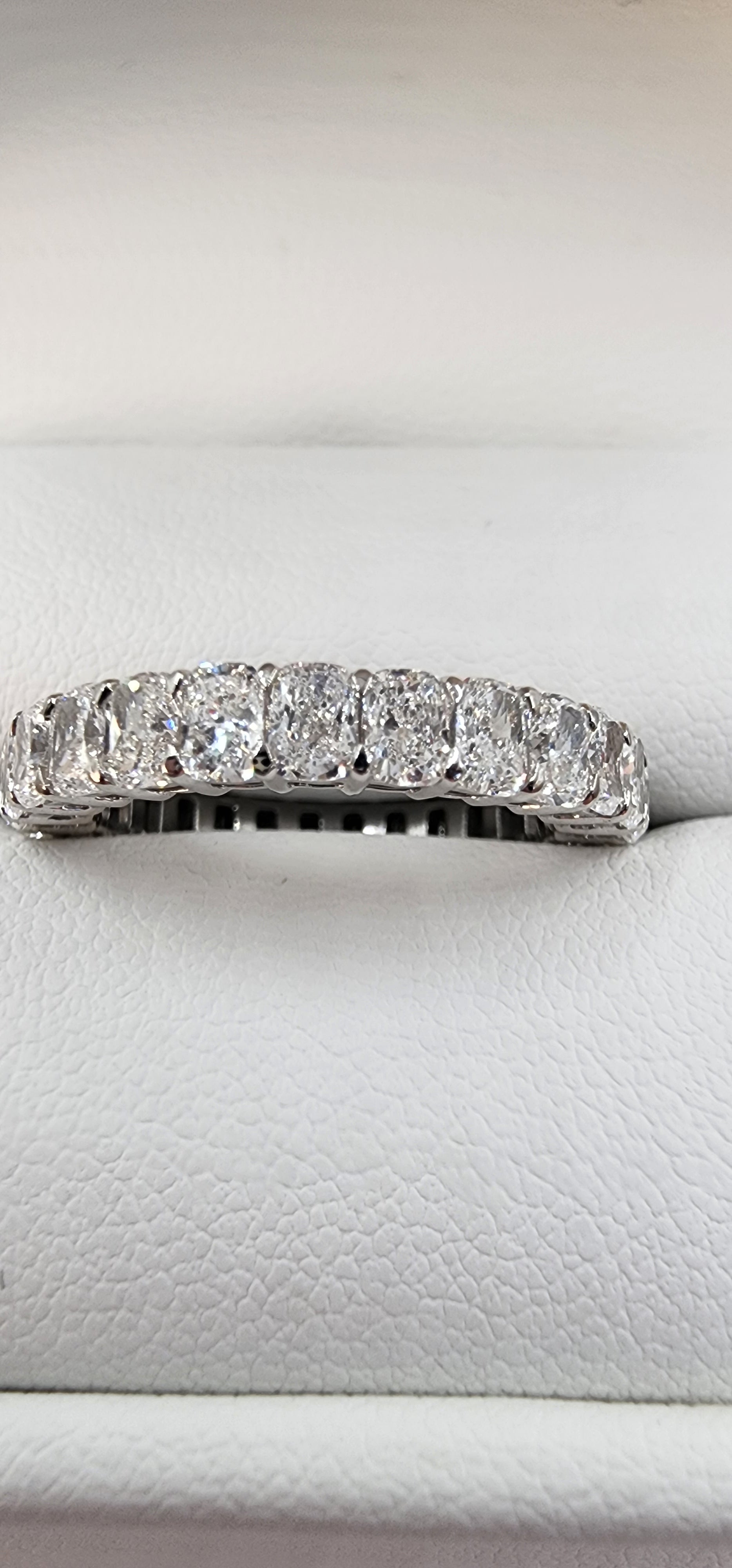 Diamond ring on a white cushioned surface