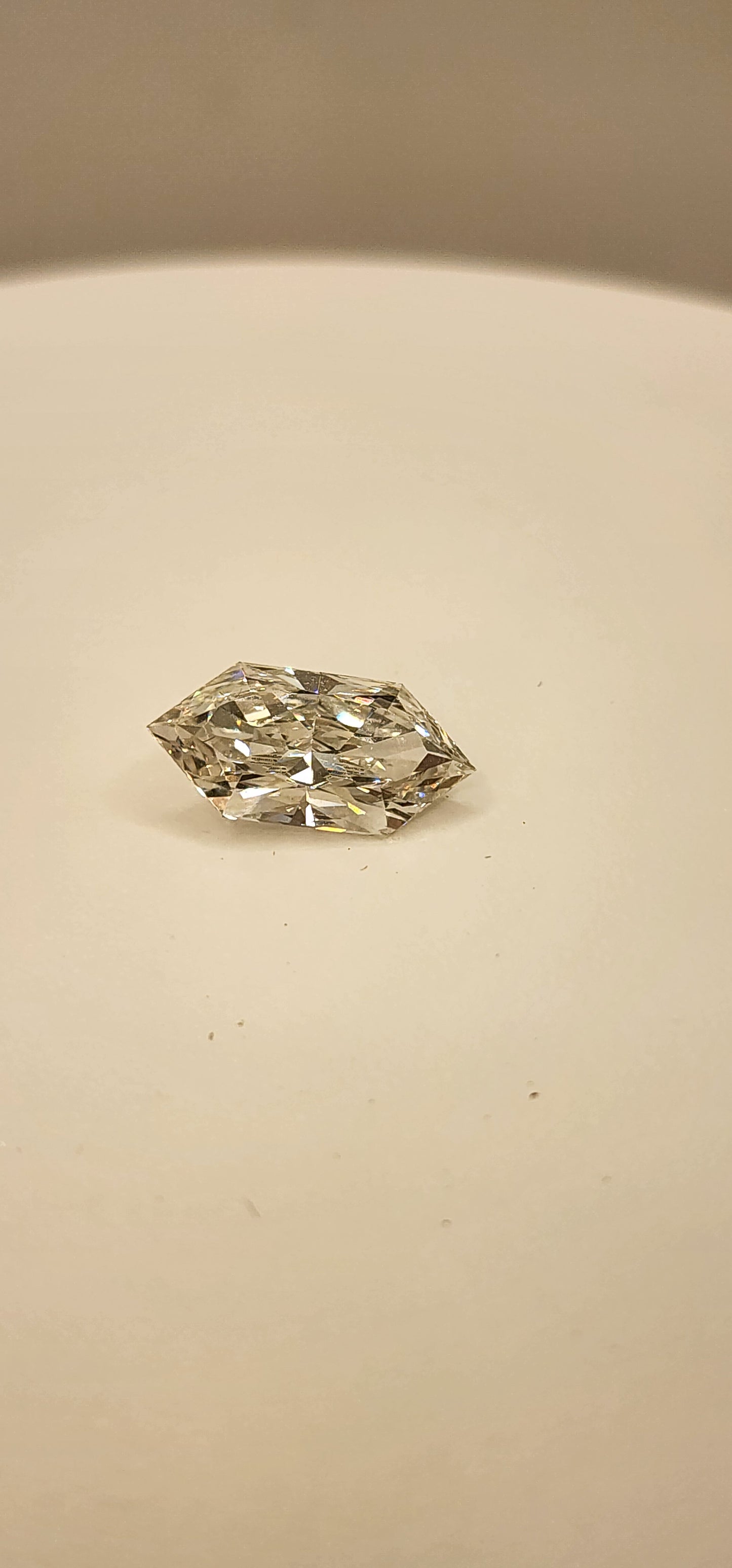 Diamond on a white display in front of a grey background