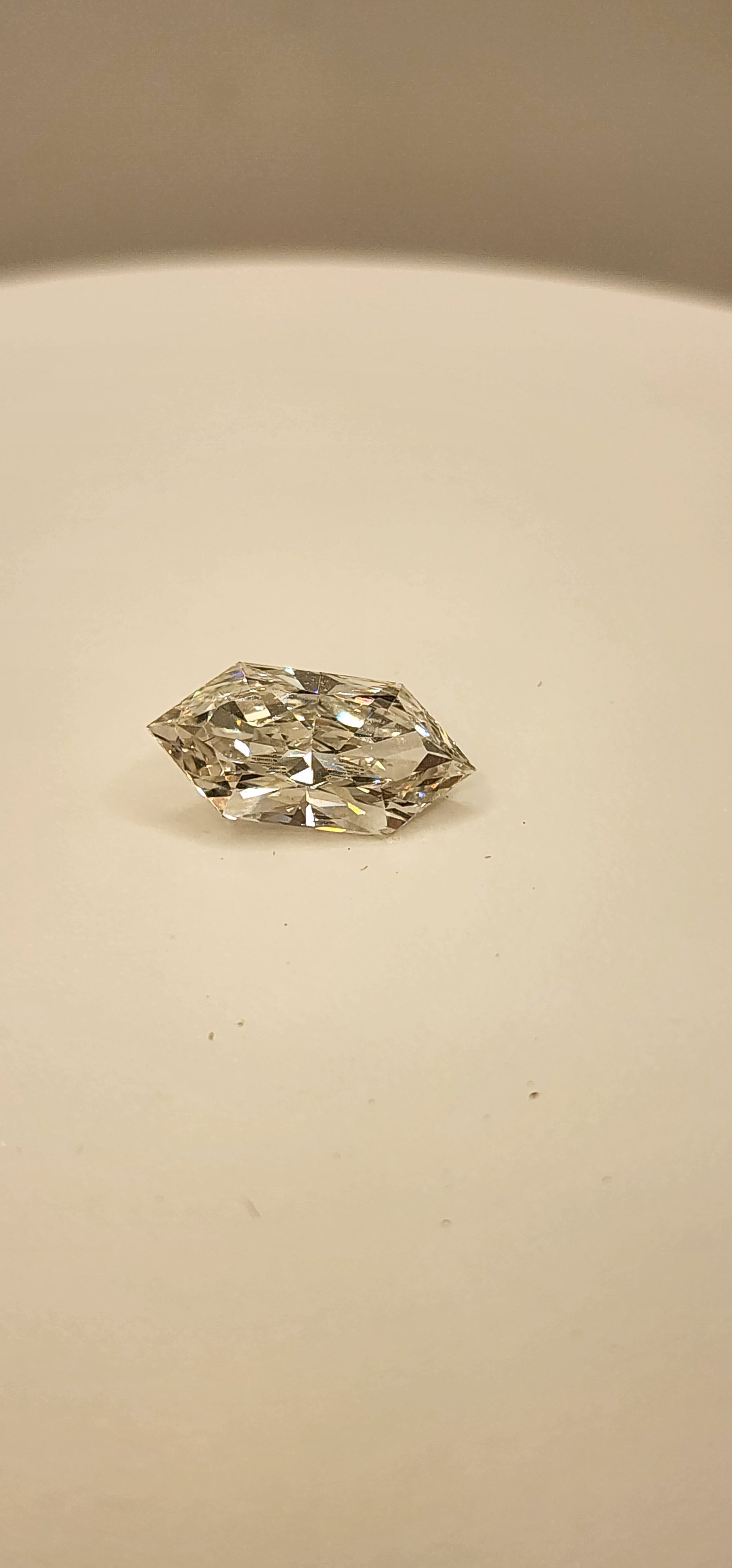Diamond on a white display in front of a grey background