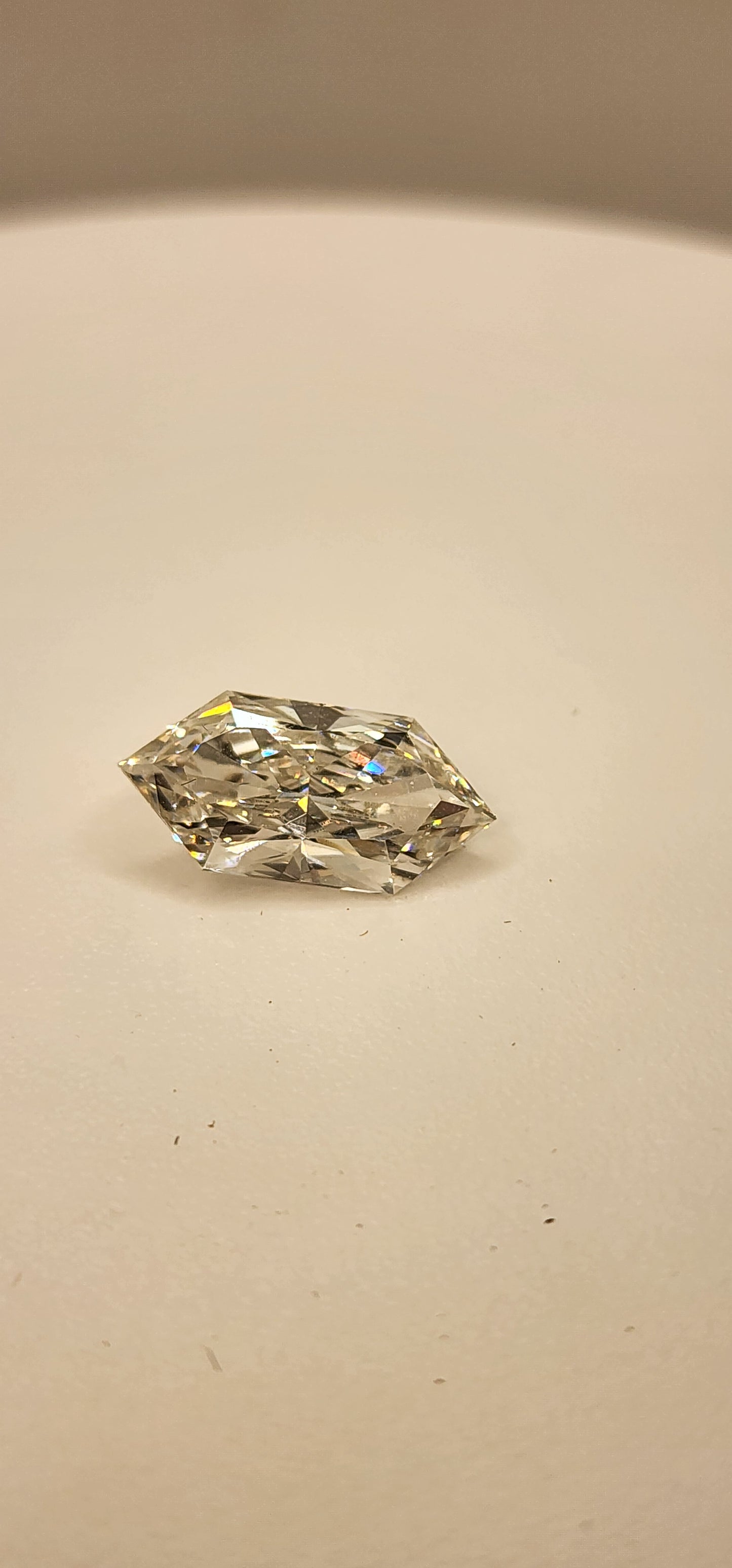 Diamond on a white display in front of a grey background