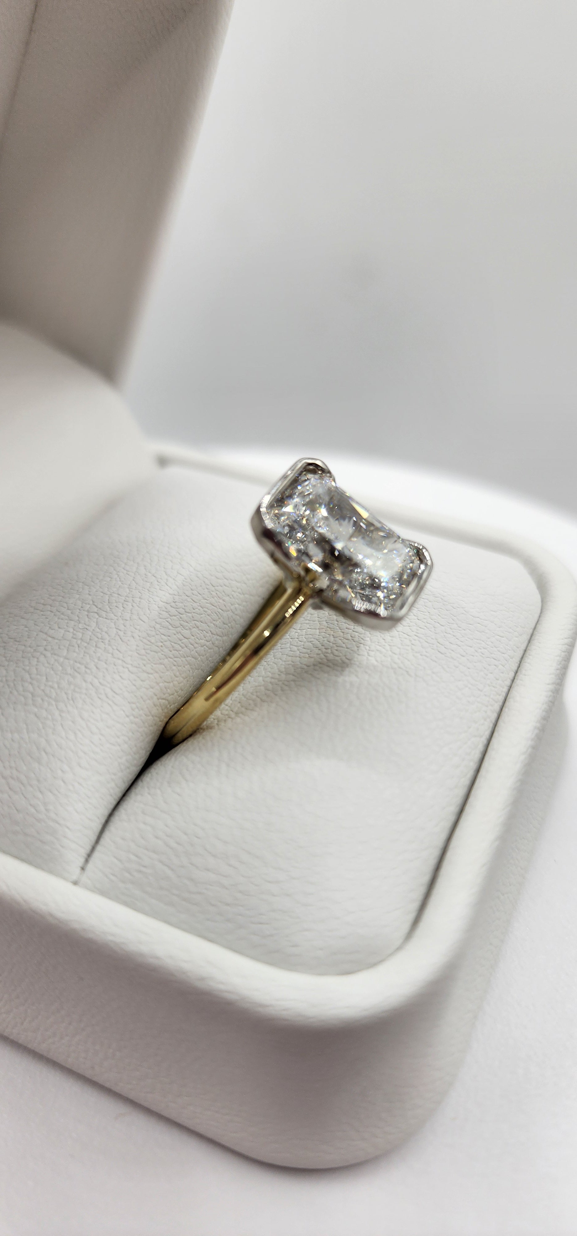 Diamond ring on a white cushioned ring box