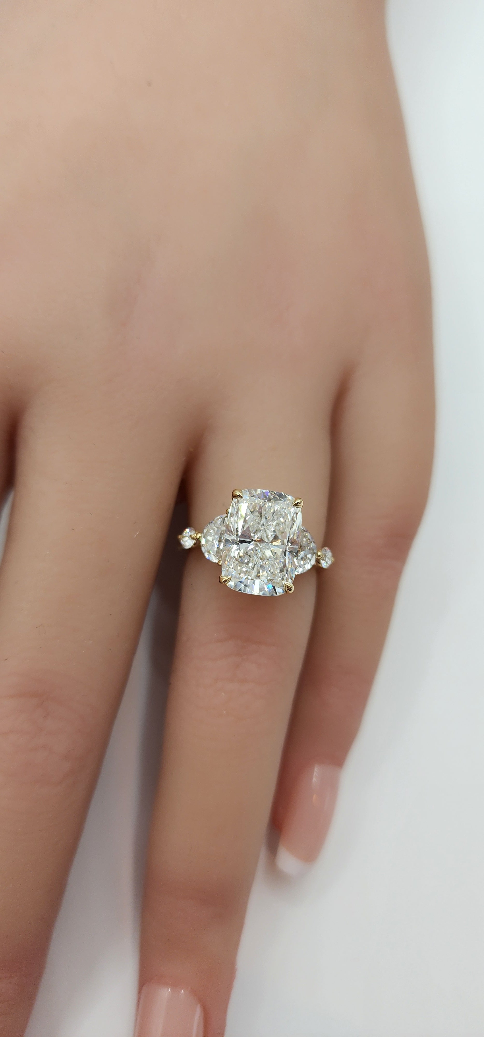 Diamond ring on a finger against a white background