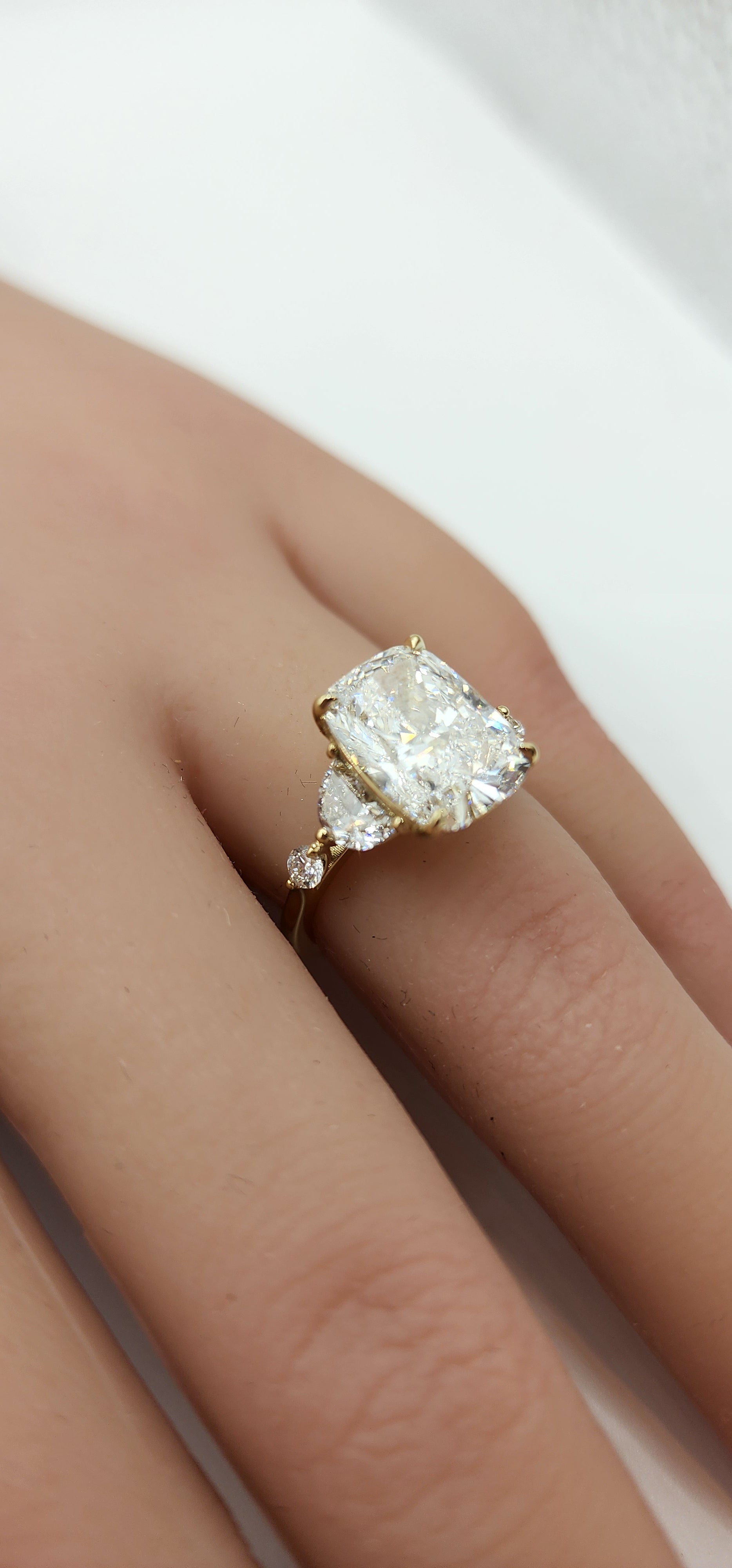 Diamond ring on a finger with a white background
