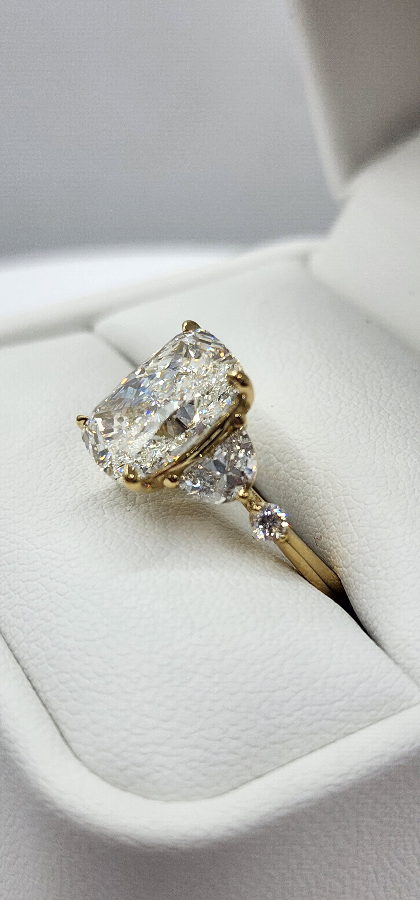 Diamond earring on a white cushion