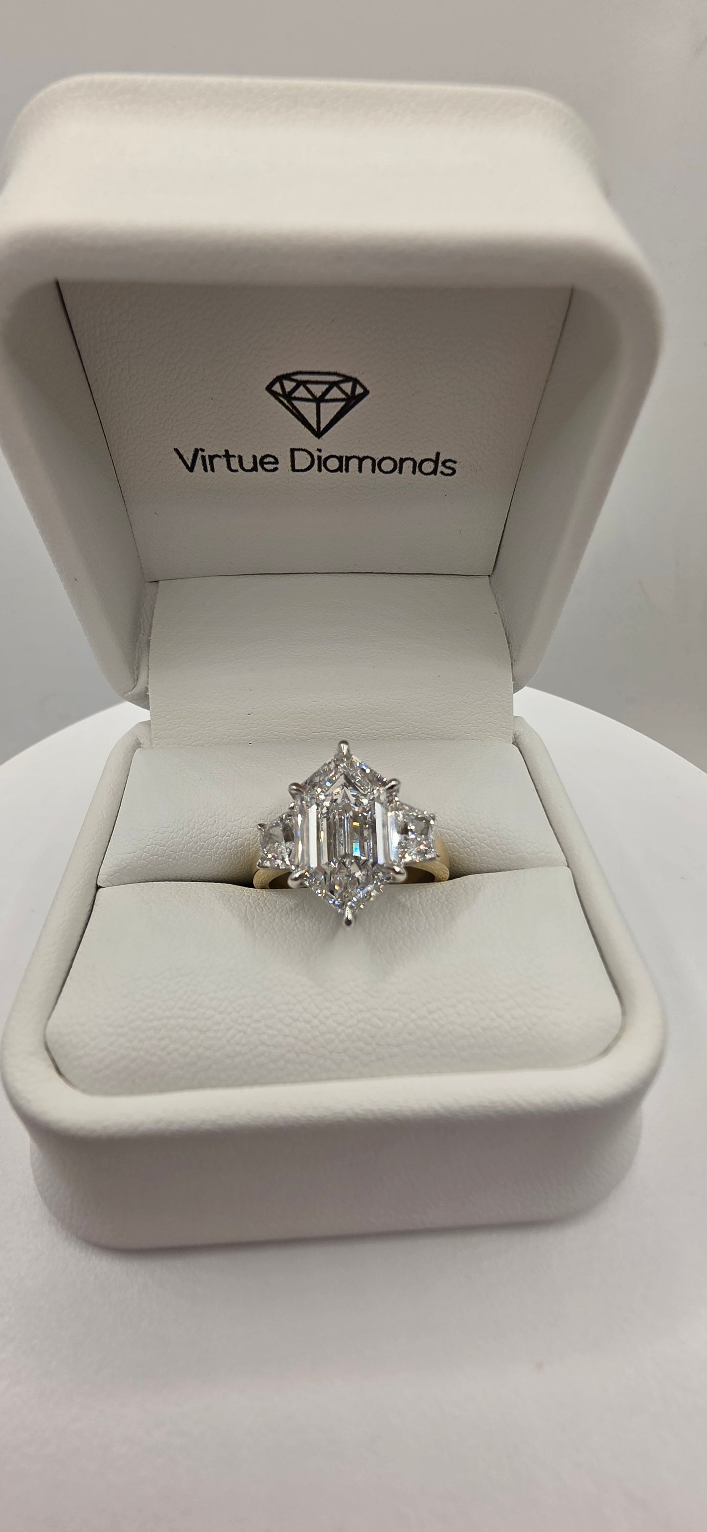 Diamond ring in a Virtue Diamonds box on a white background