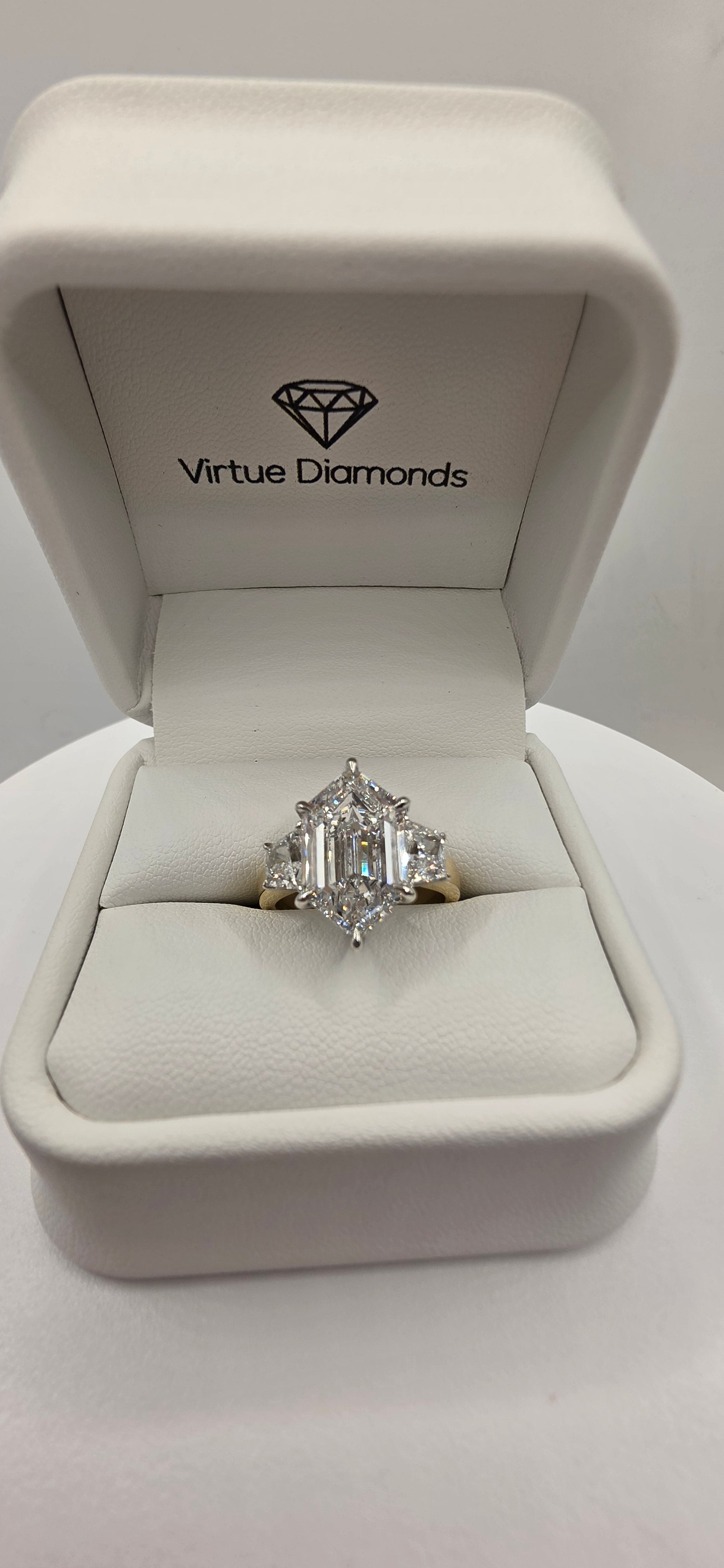 Diamond ring in a Virtue Diamonds box on a white background