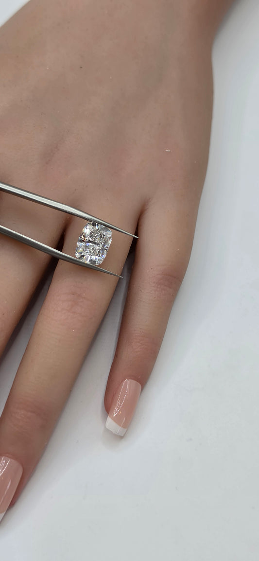 Hand wearing a silver ring with a diamond on a white background