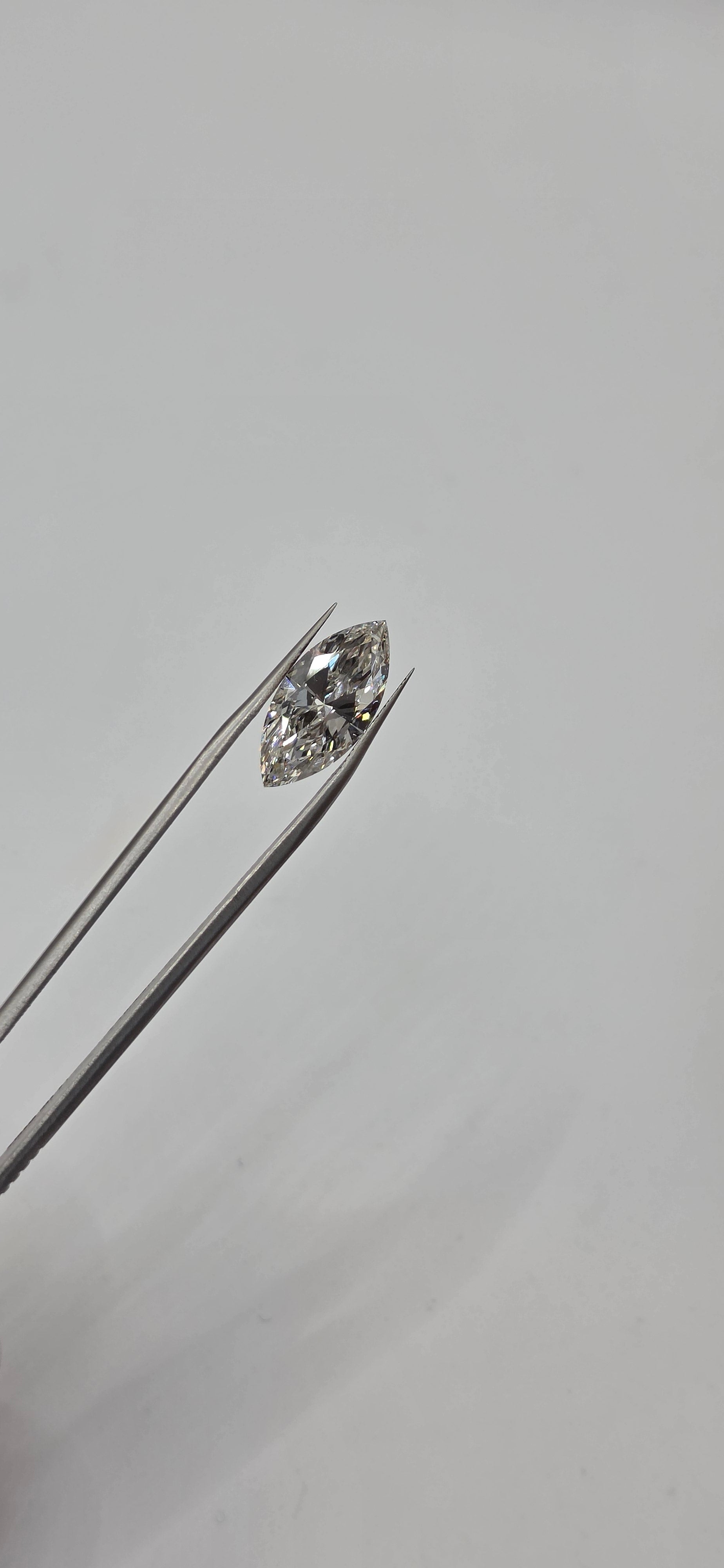 Diamond on a thin metal rod against a light gray background