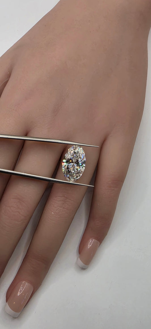 Hand wearing a diamond ring on a white background