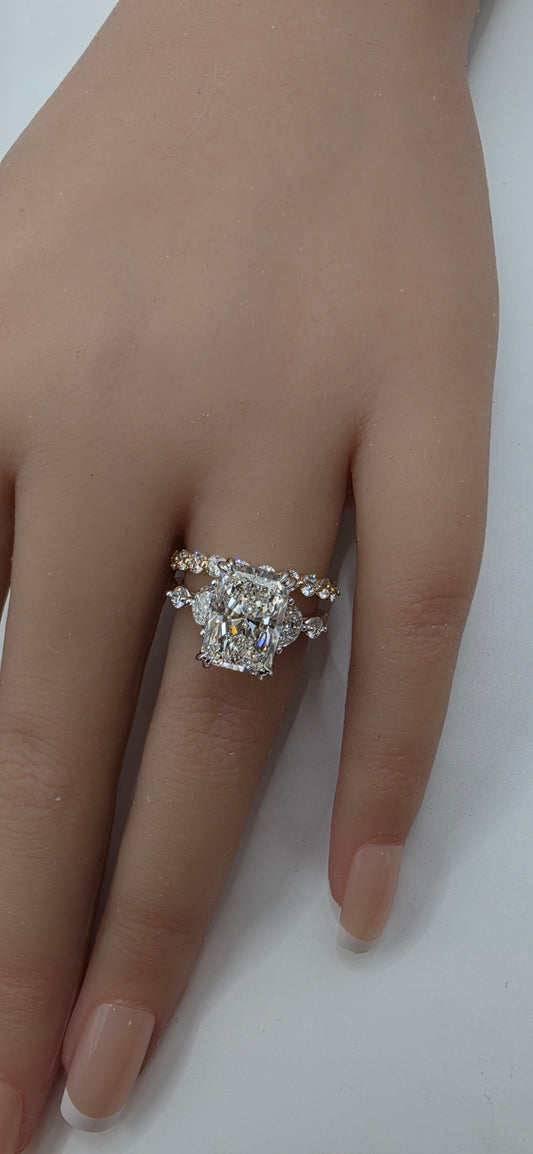 Hand wearing a diamond ring on a plain background
