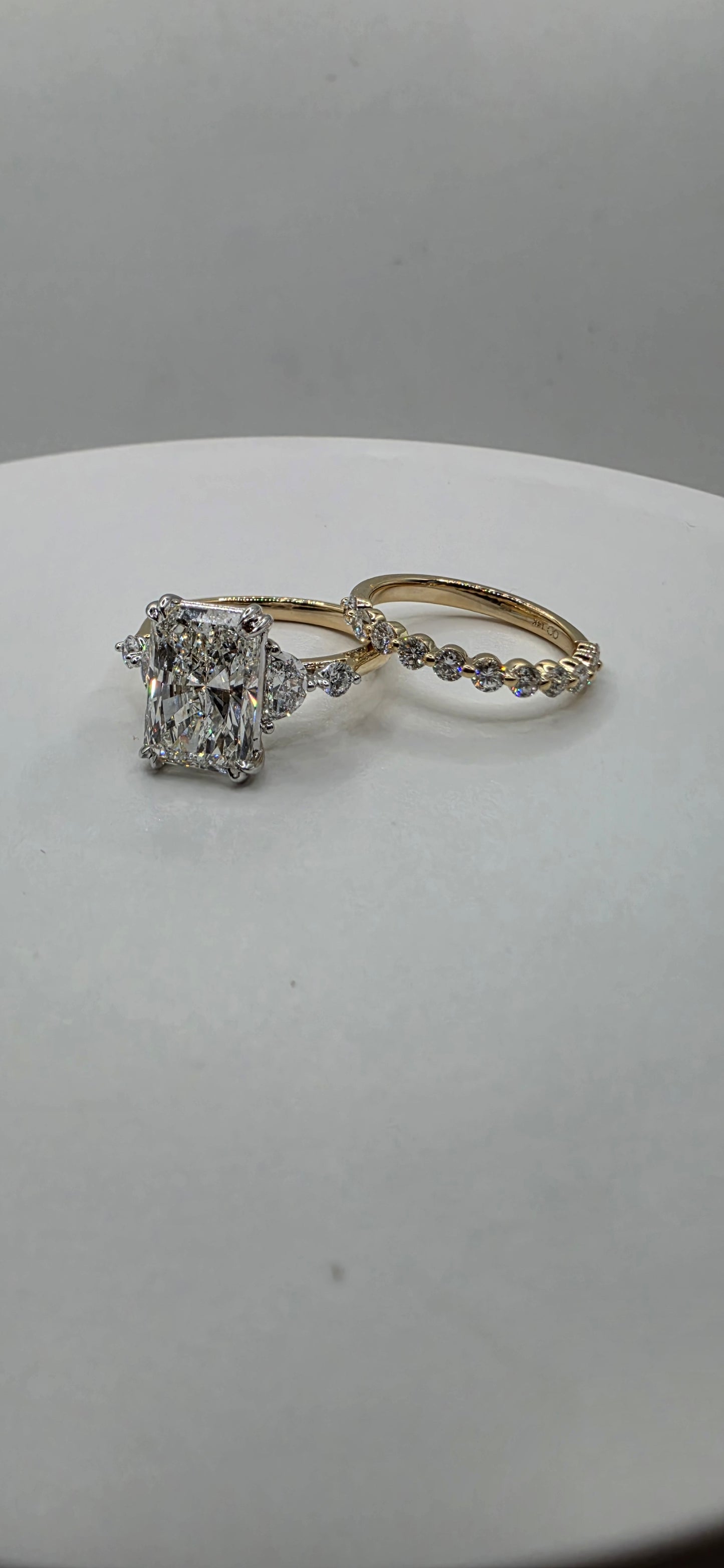 Yellow gold diamond ring set on a light gray background
