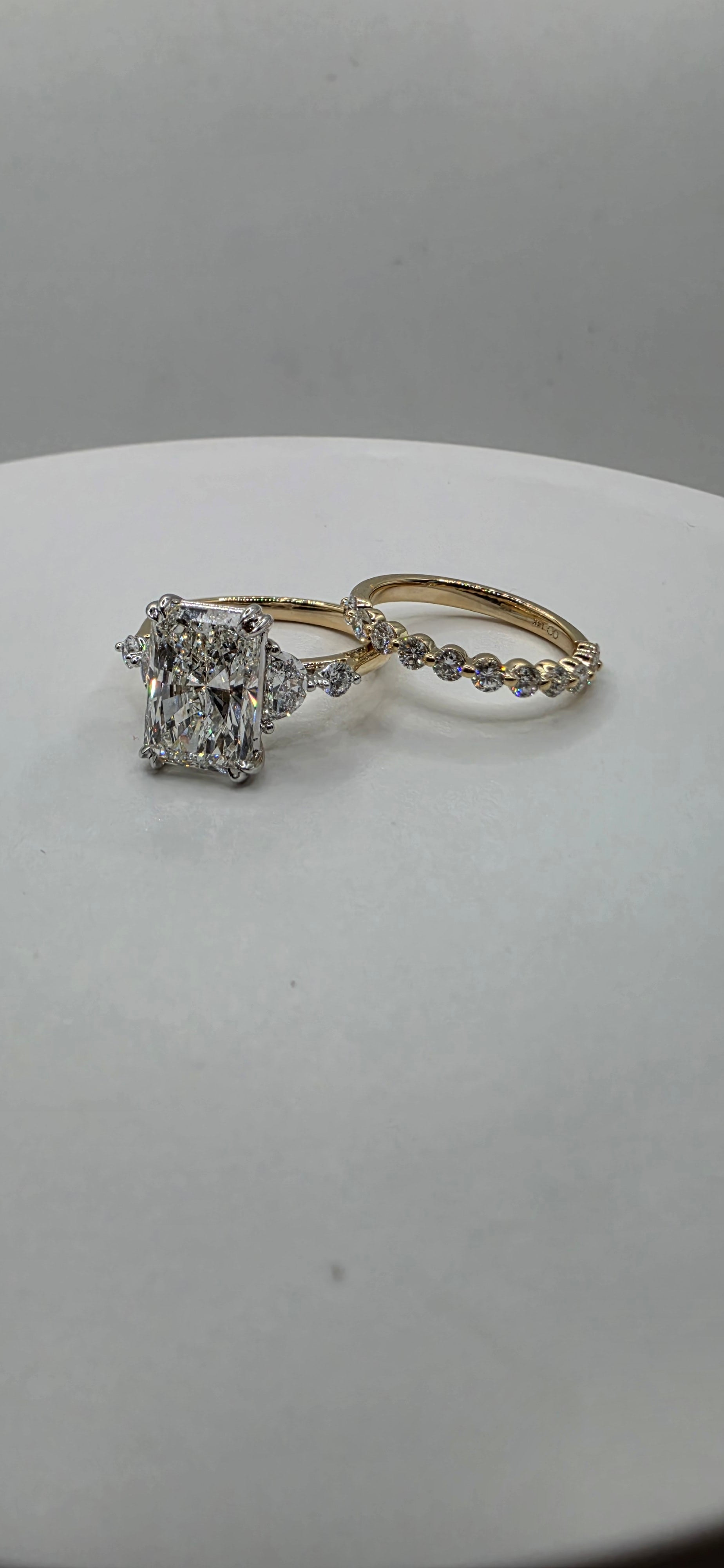 Yellow gold diamond ring set on a light gray background