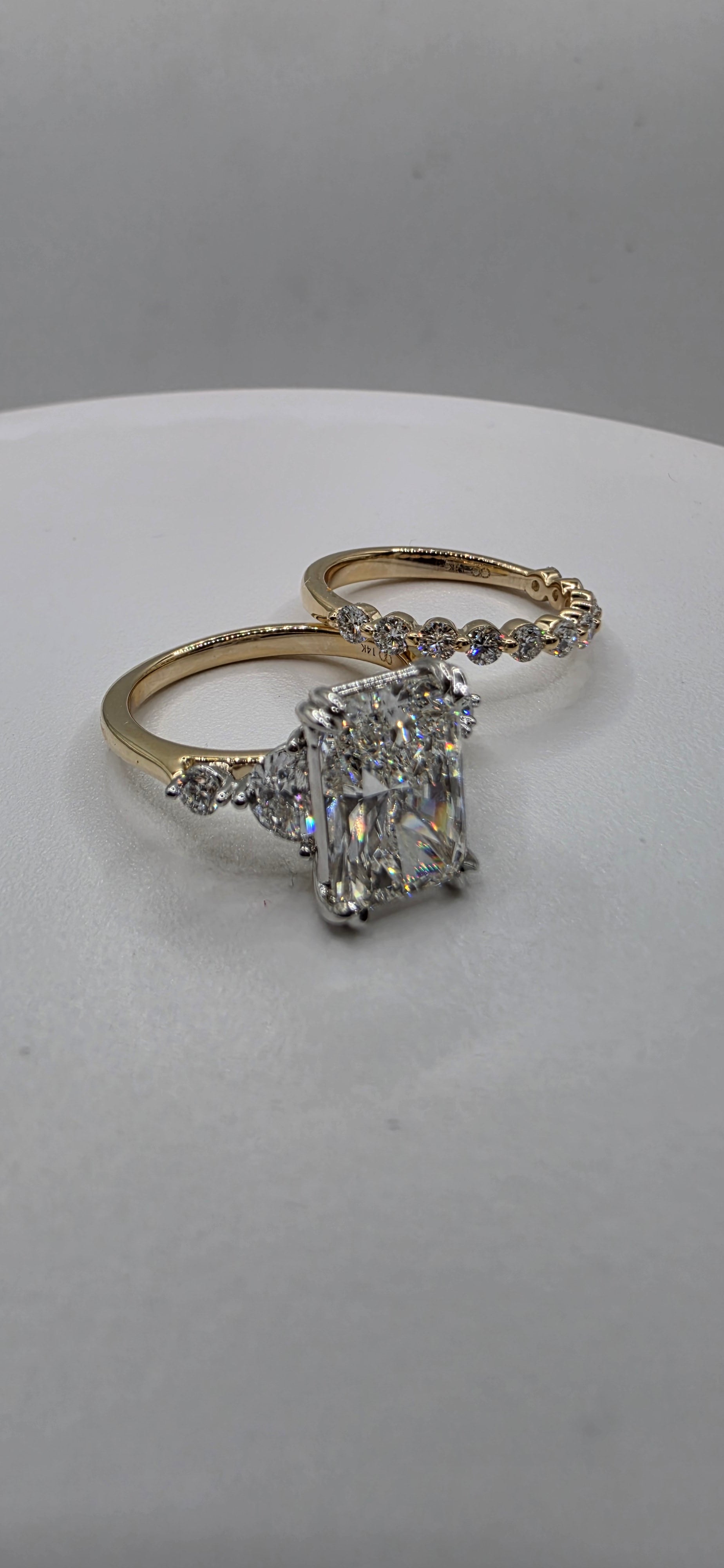 Yellow gold diamond ring set on a light gray background