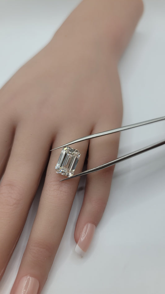 A close-up of a hand with a emerald cut lab diamond