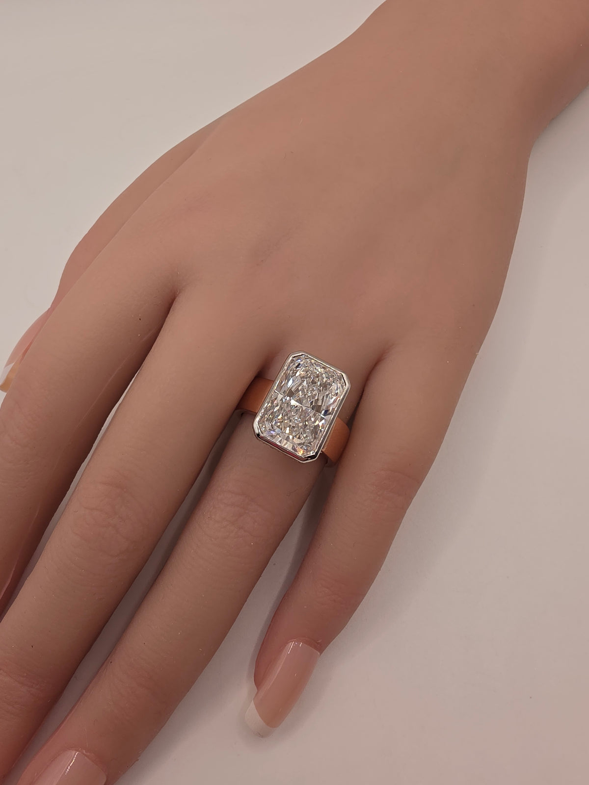 Diamond ring on a hand by white background