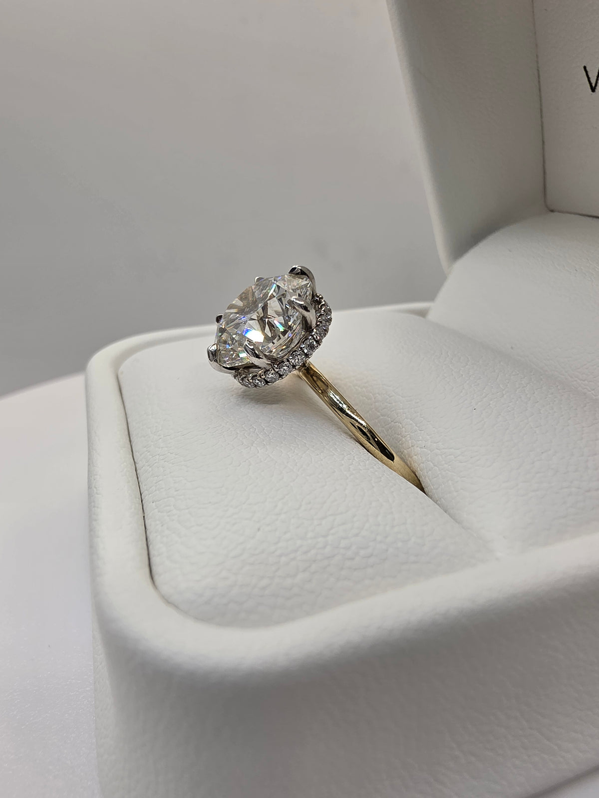 Round diamond ring with yellow gold on a white background
