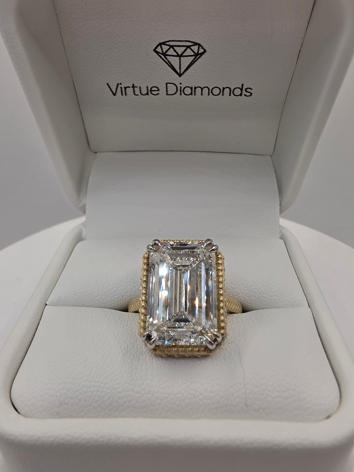 Emerald Diamond and yellow gold ring with millgrain detail in white ring box