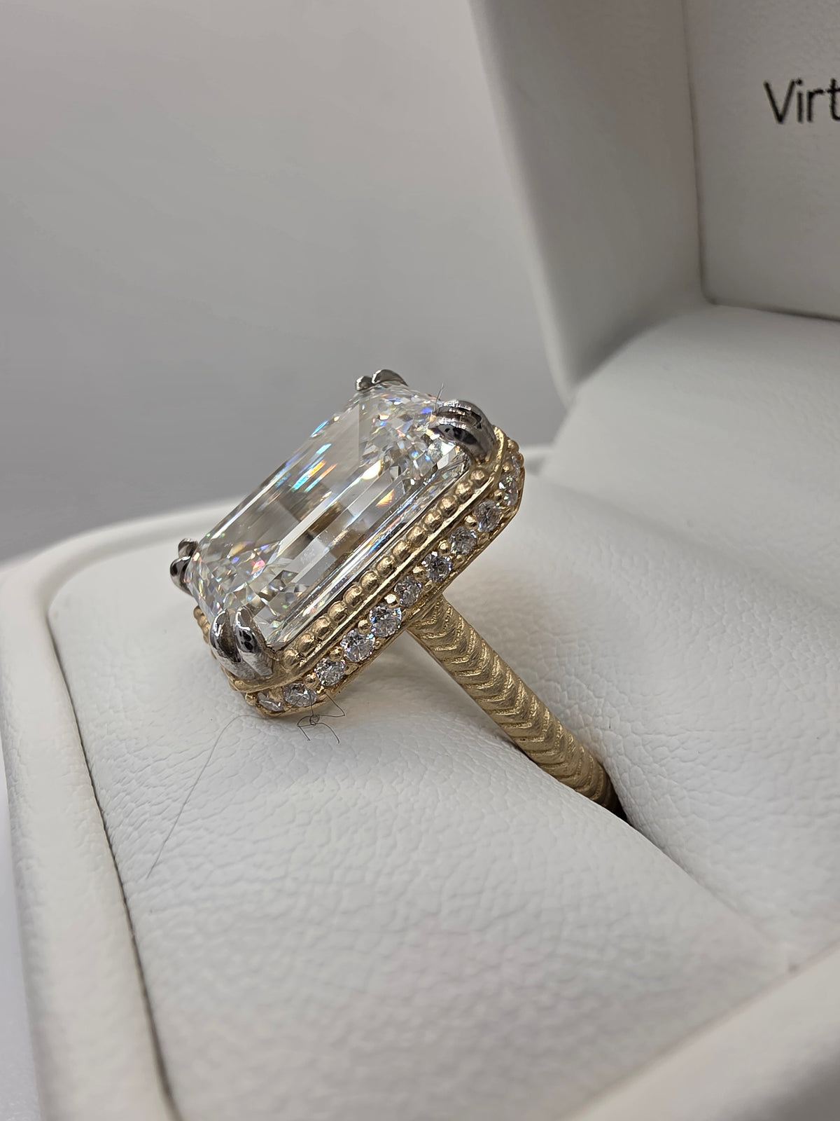 Emerald Diamond and yellow gold ring with millgrain detail in white ring box