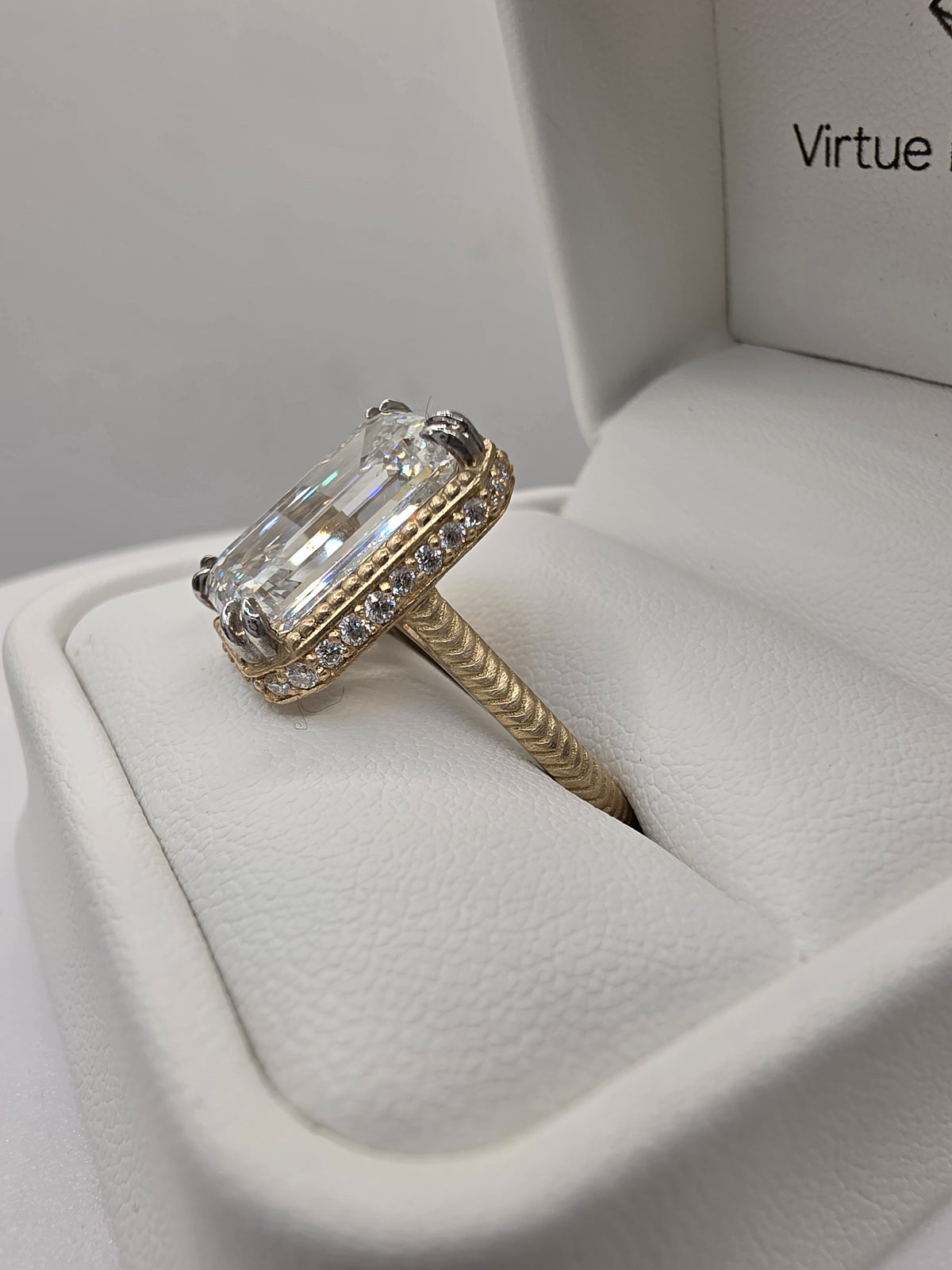 Emerald Diamond and yellow gold ring with millgrain detail in white ring box