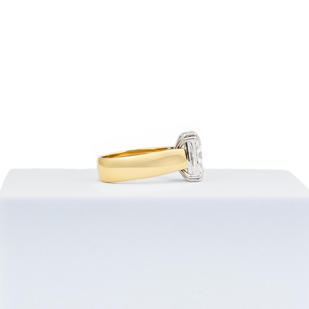 Gold and diamond ring on a white background