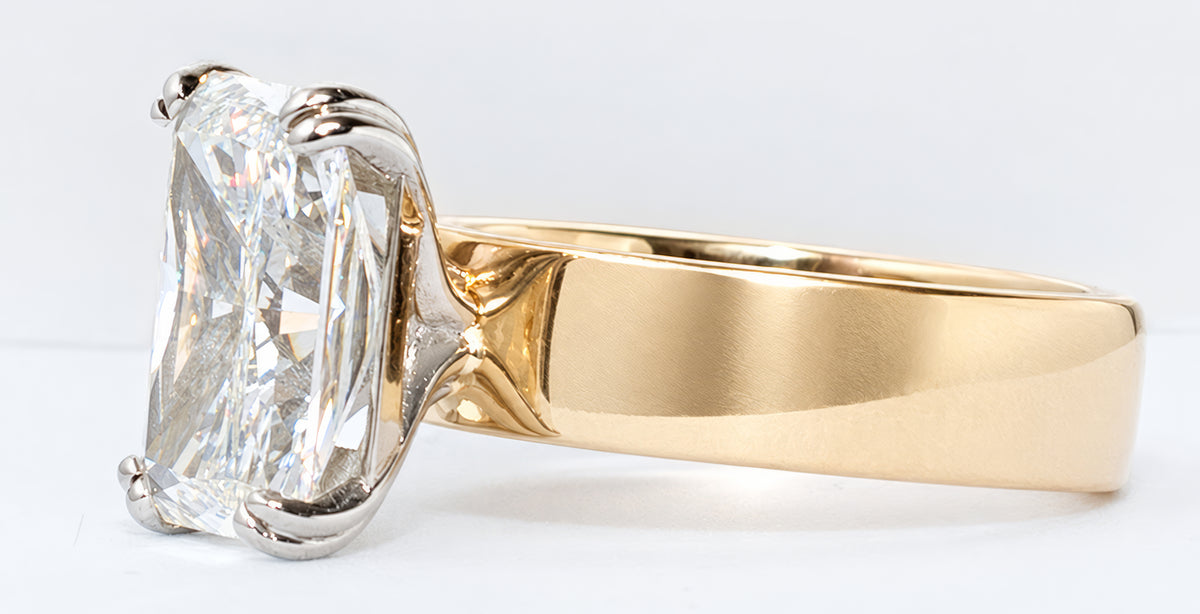Gold and diamond ring on a white background