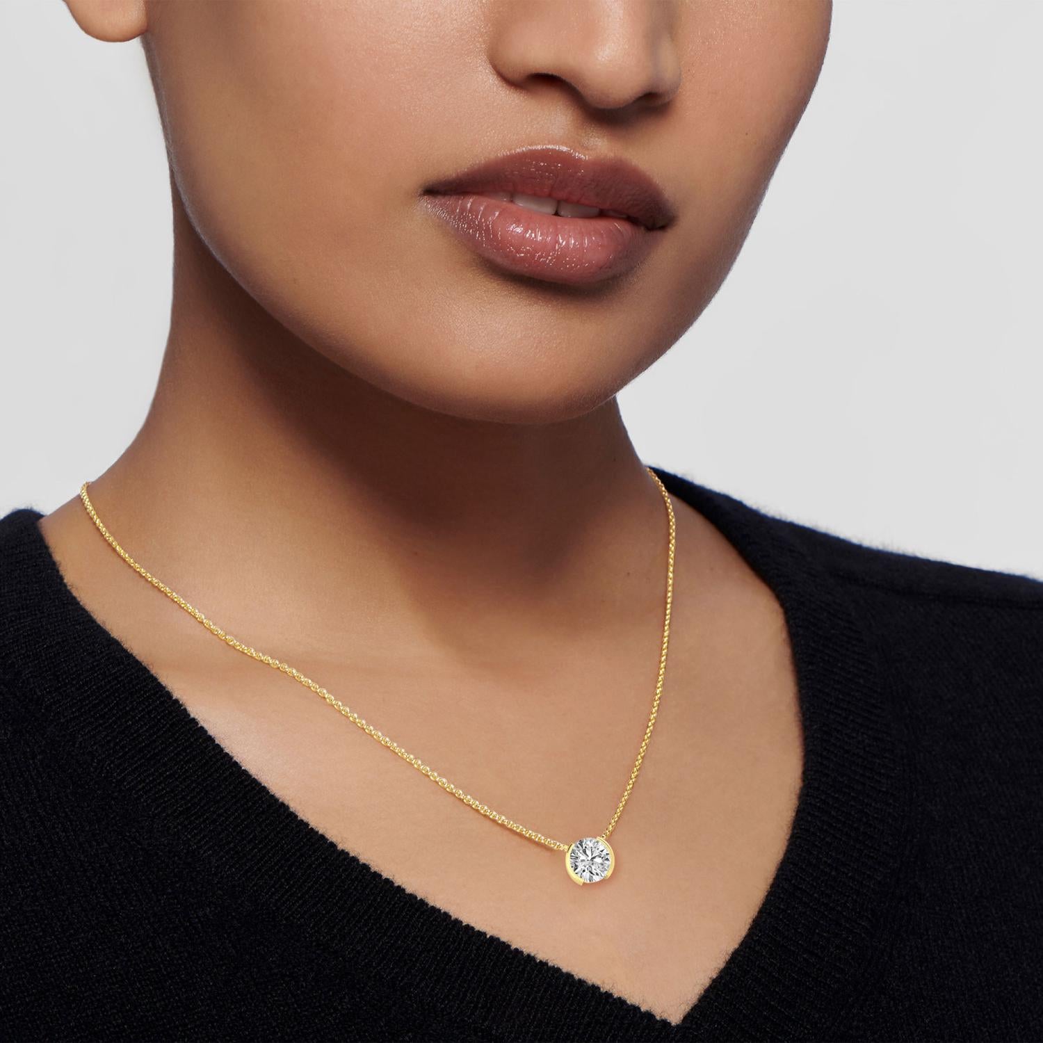 yellow gold diamond necklace around a woman's neck