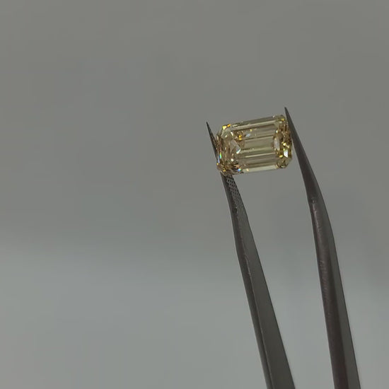 Video of yellow lab grown diamond held in tweezers