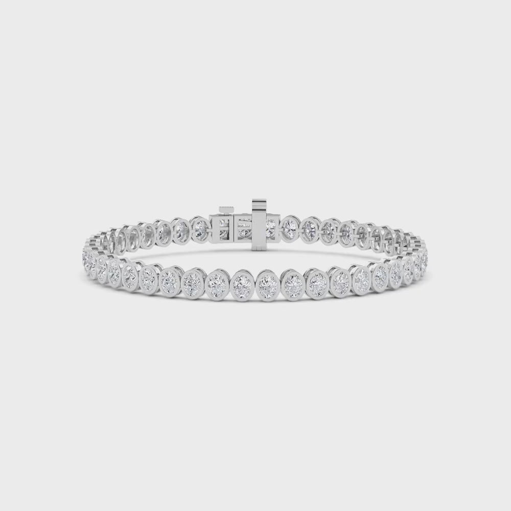 white gold and diamond bracelet in front of a white background