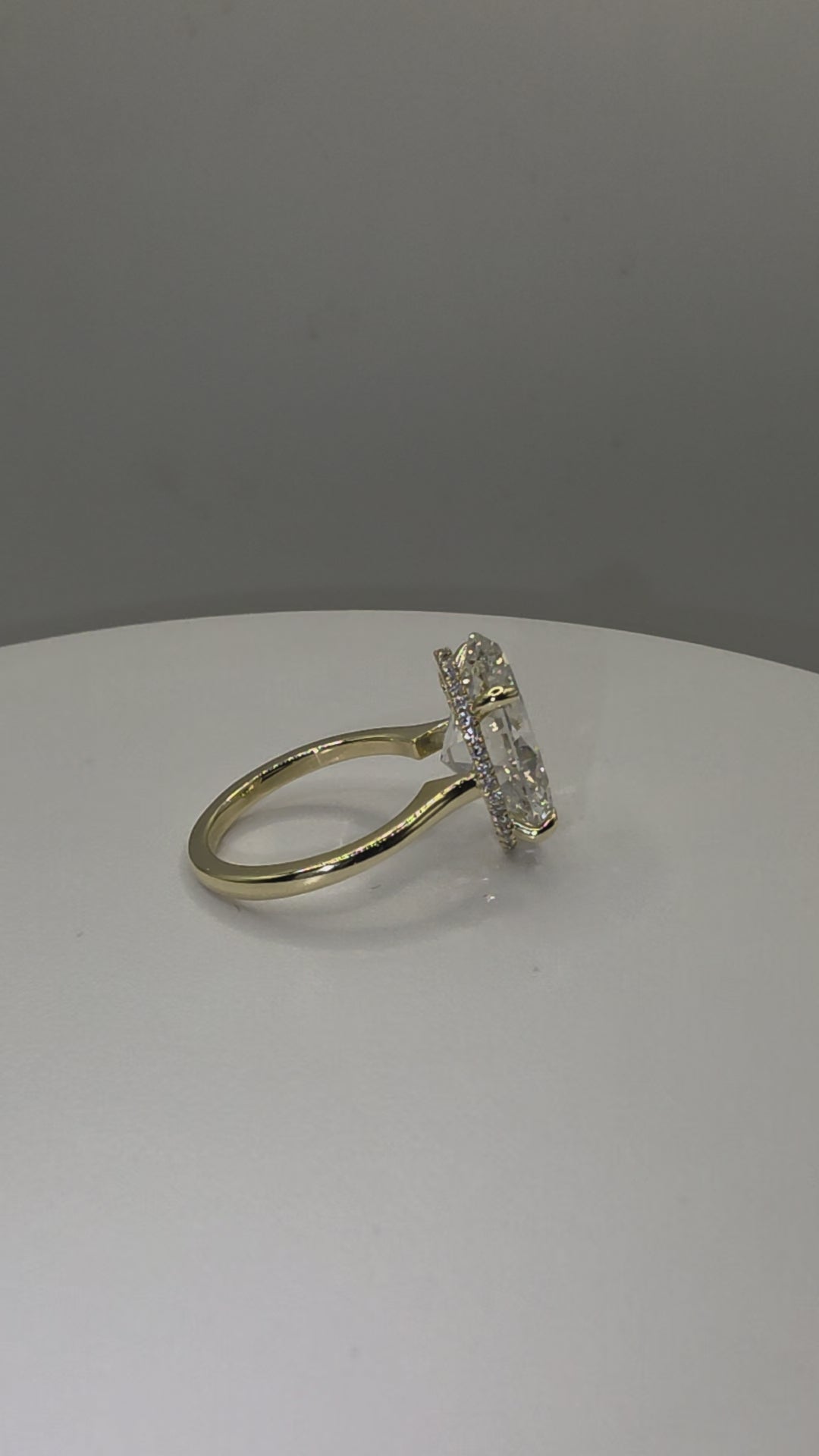 An oval diamond ring on a plain white background