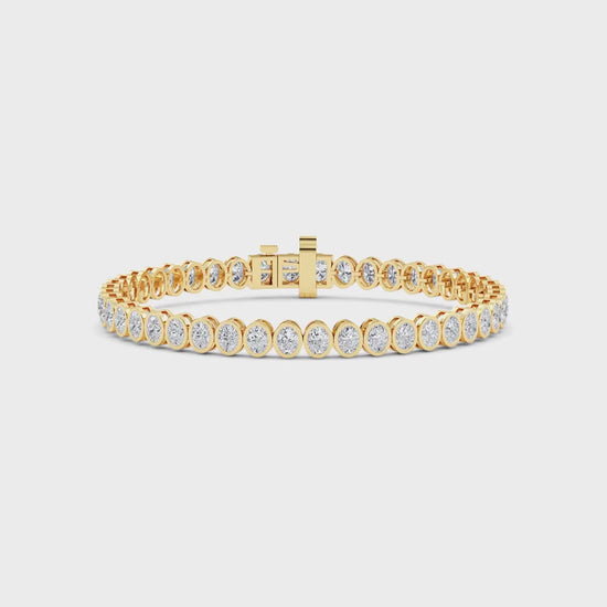 yellow gold and diamond bracelet in front of a white background