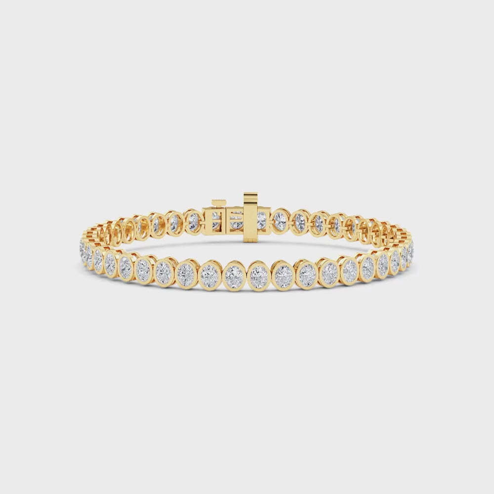 yellow gold and diamond bracelet in front of a white background