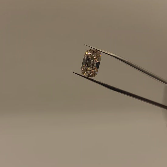 Video of lab diamond, brown tint, held in tweezers