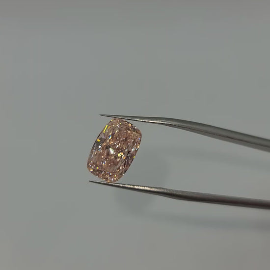 Video of pink lab grown diamond held by tweezers